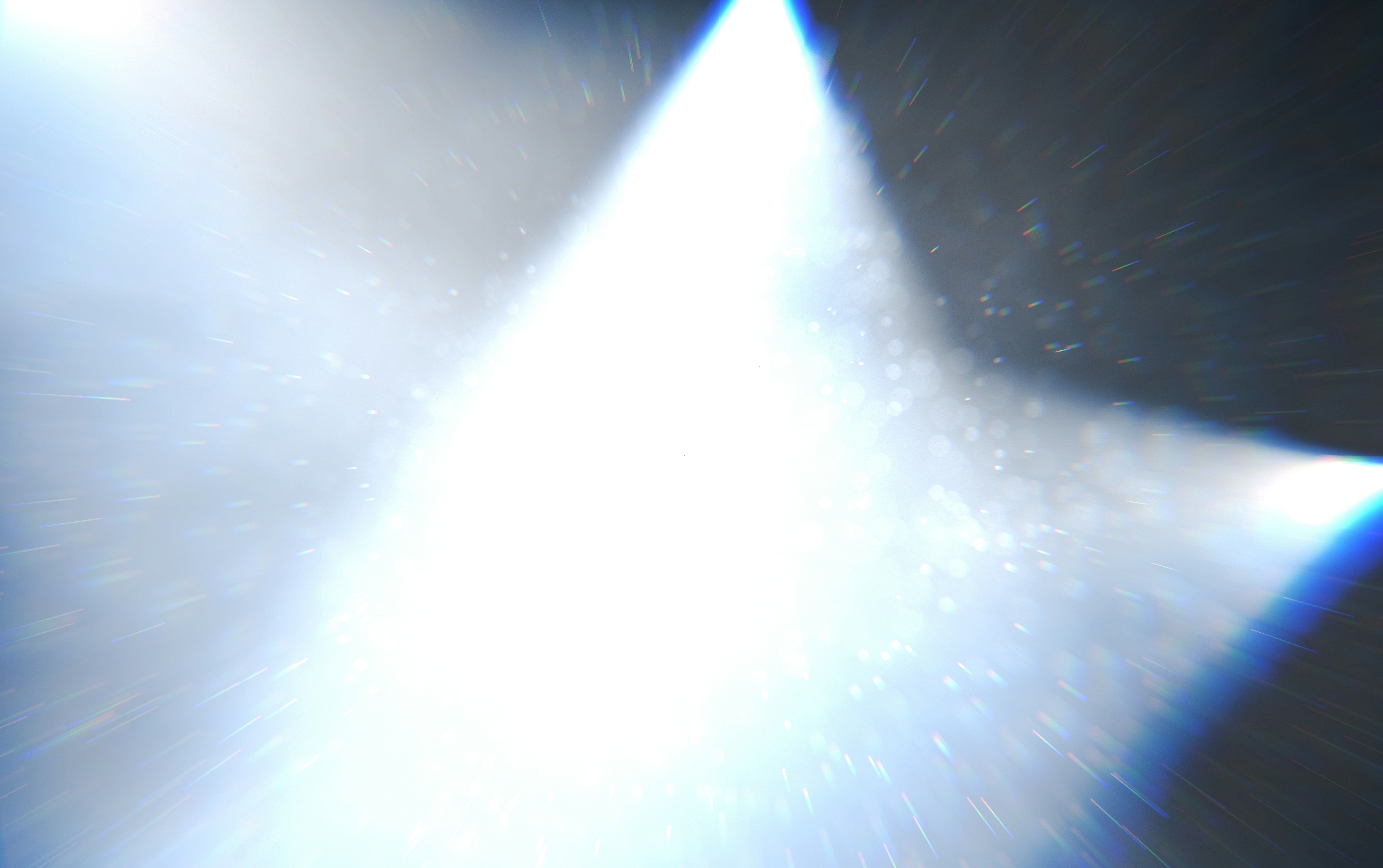 a white light shines brightly on a black background