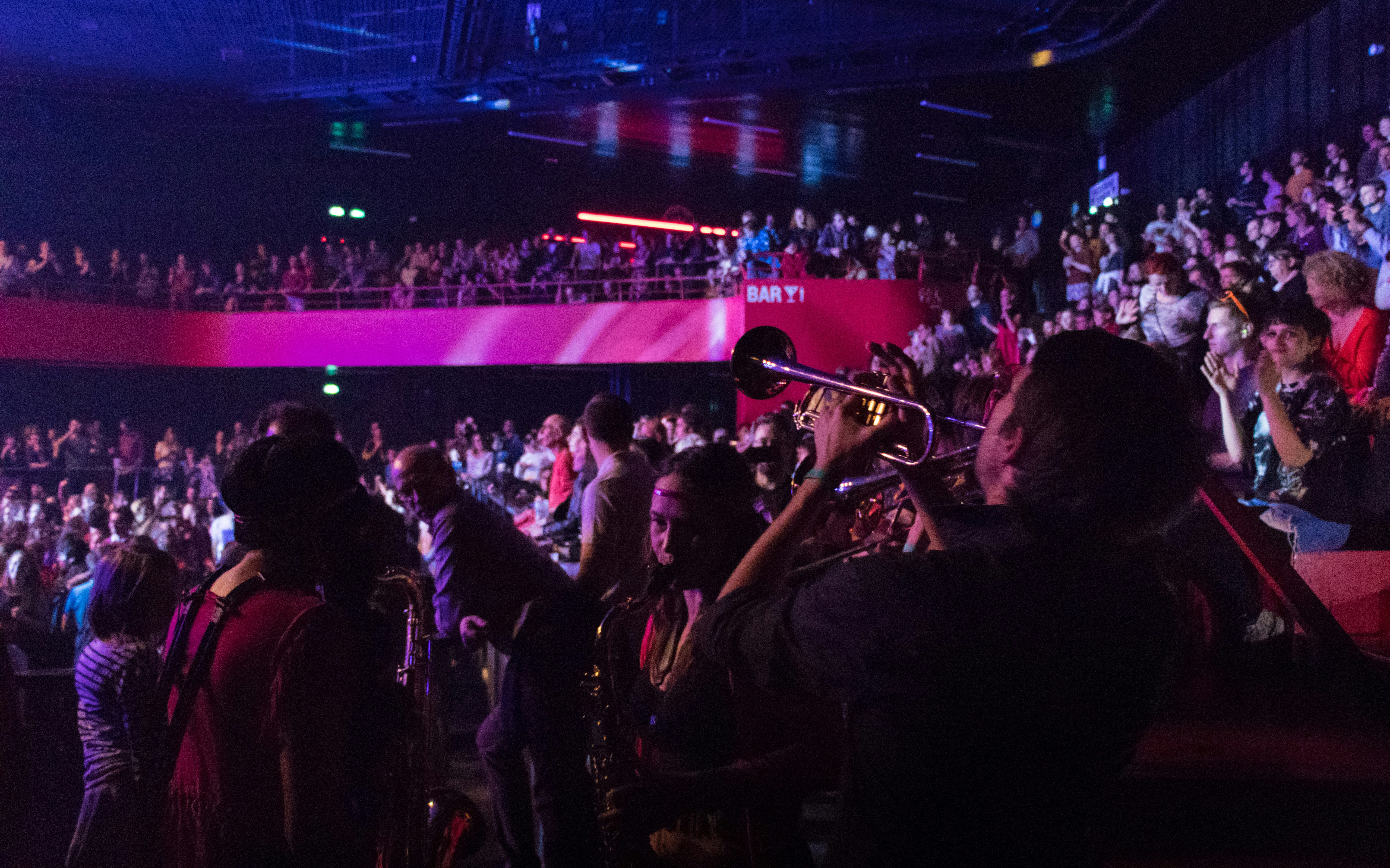 A large crowd of people in a large auditorium