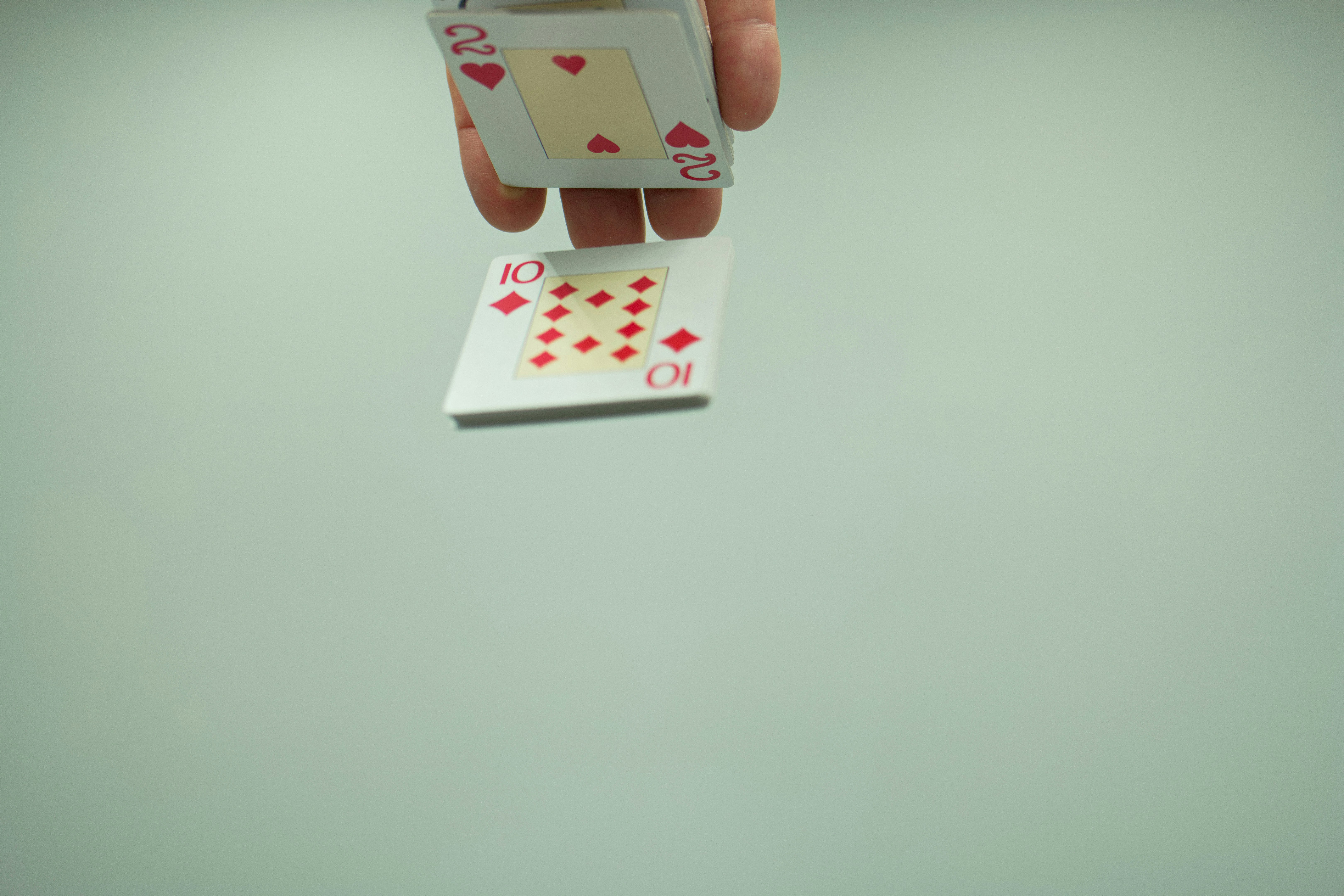 a person holding a playing card in their hand