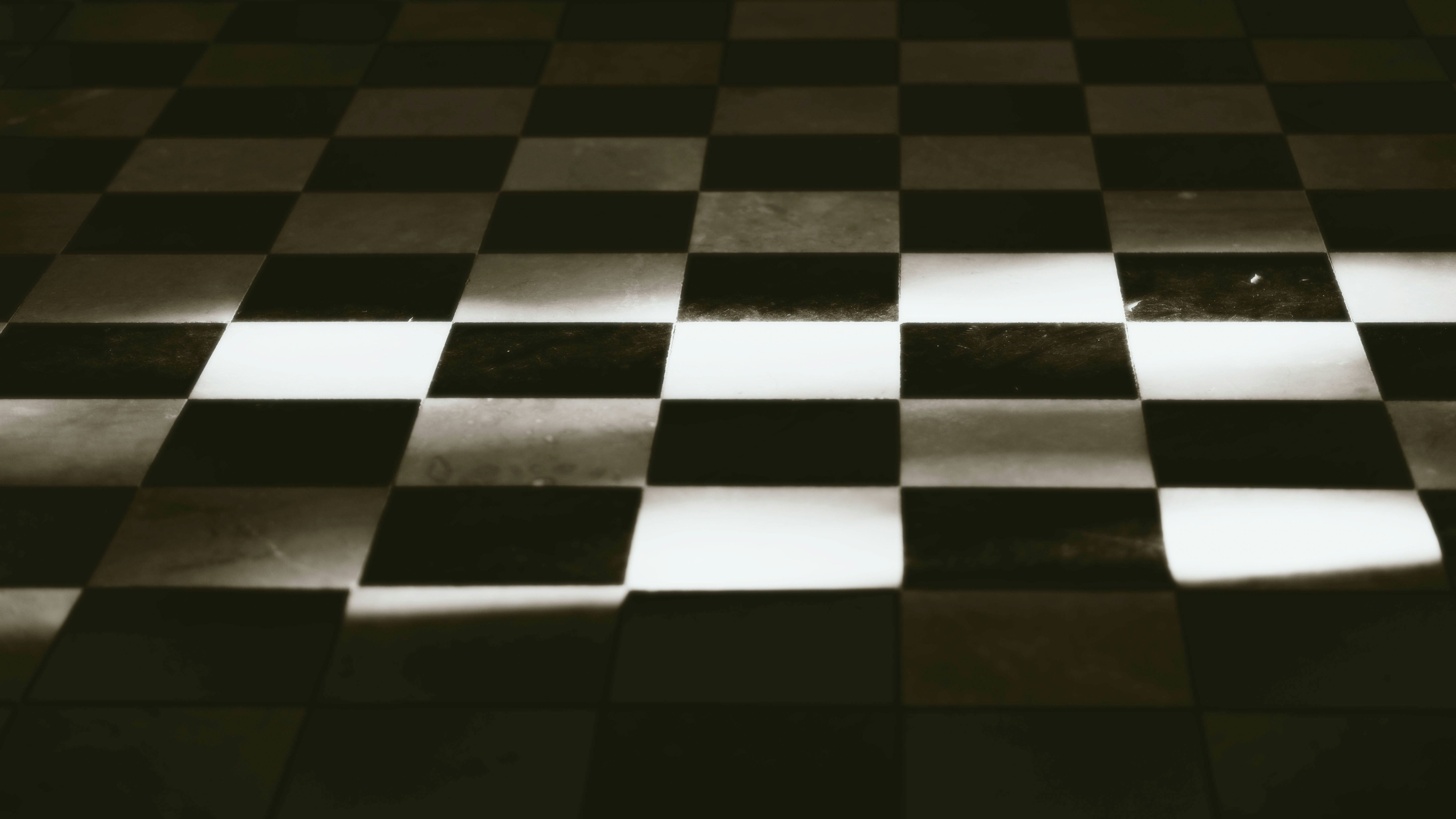 A black and white photo of a checkered floor