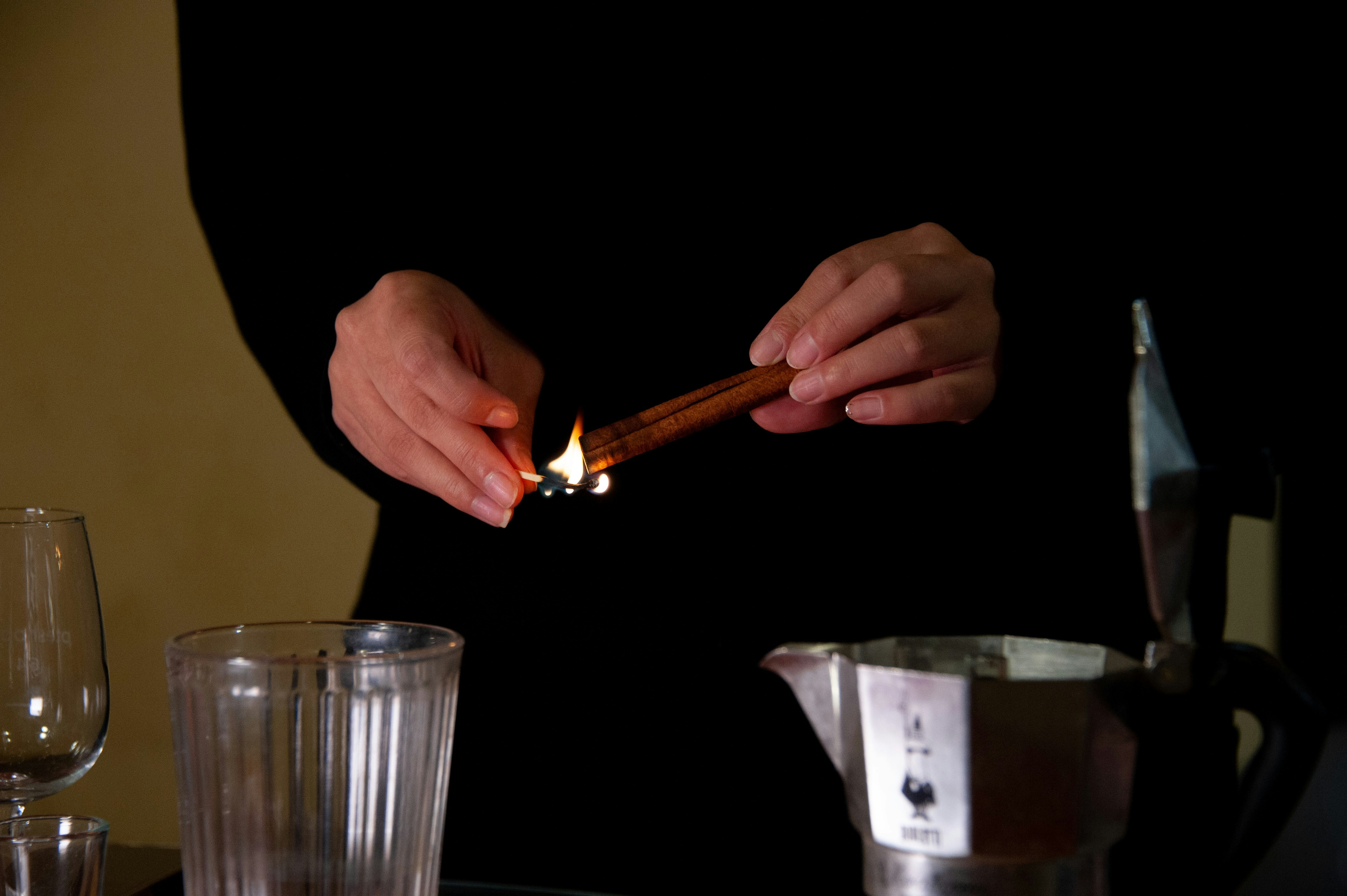 A person lighting a cigarette on a table