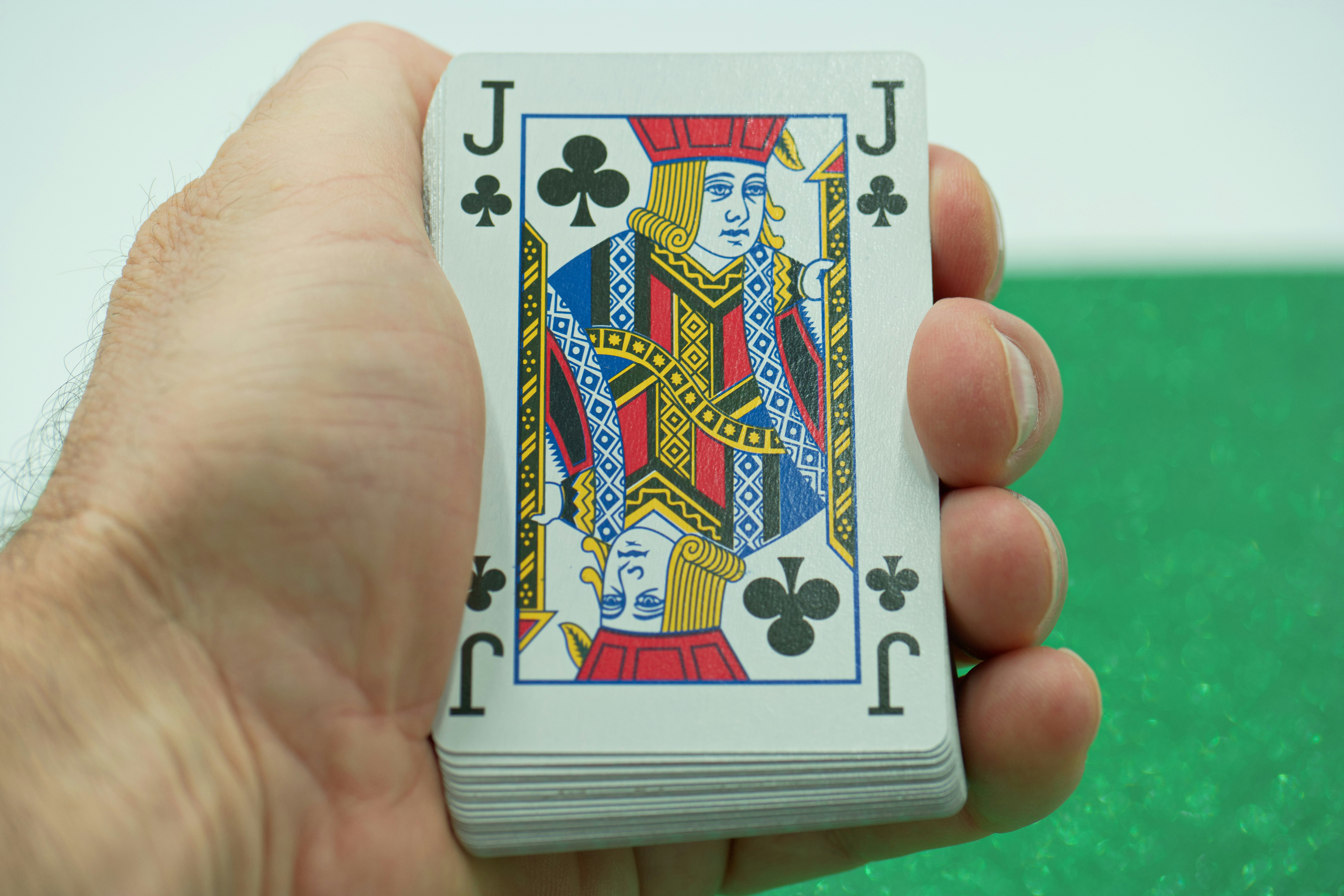 a person holding a playing card in their hand
