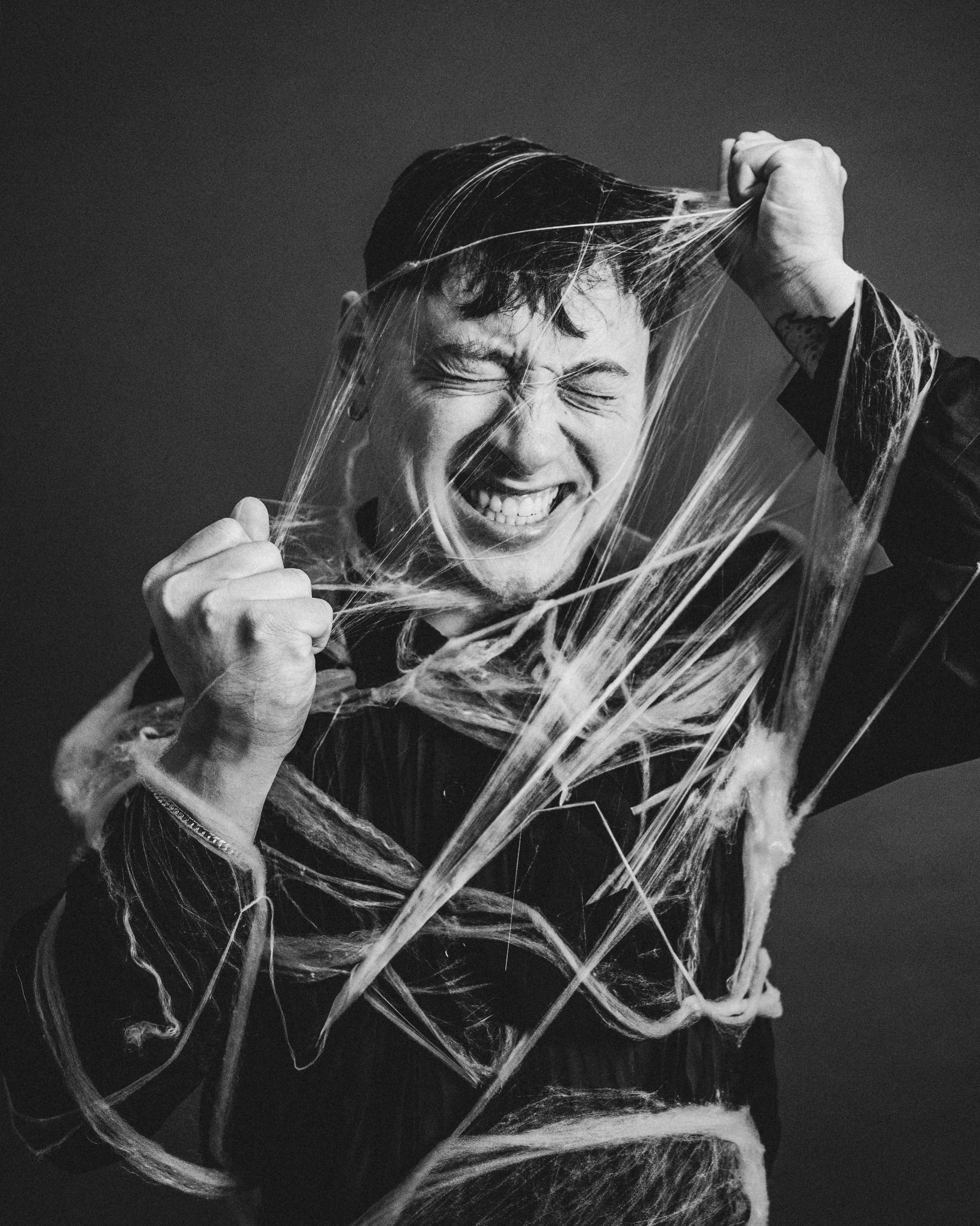 a man holding a bunch of string wrapped around his head