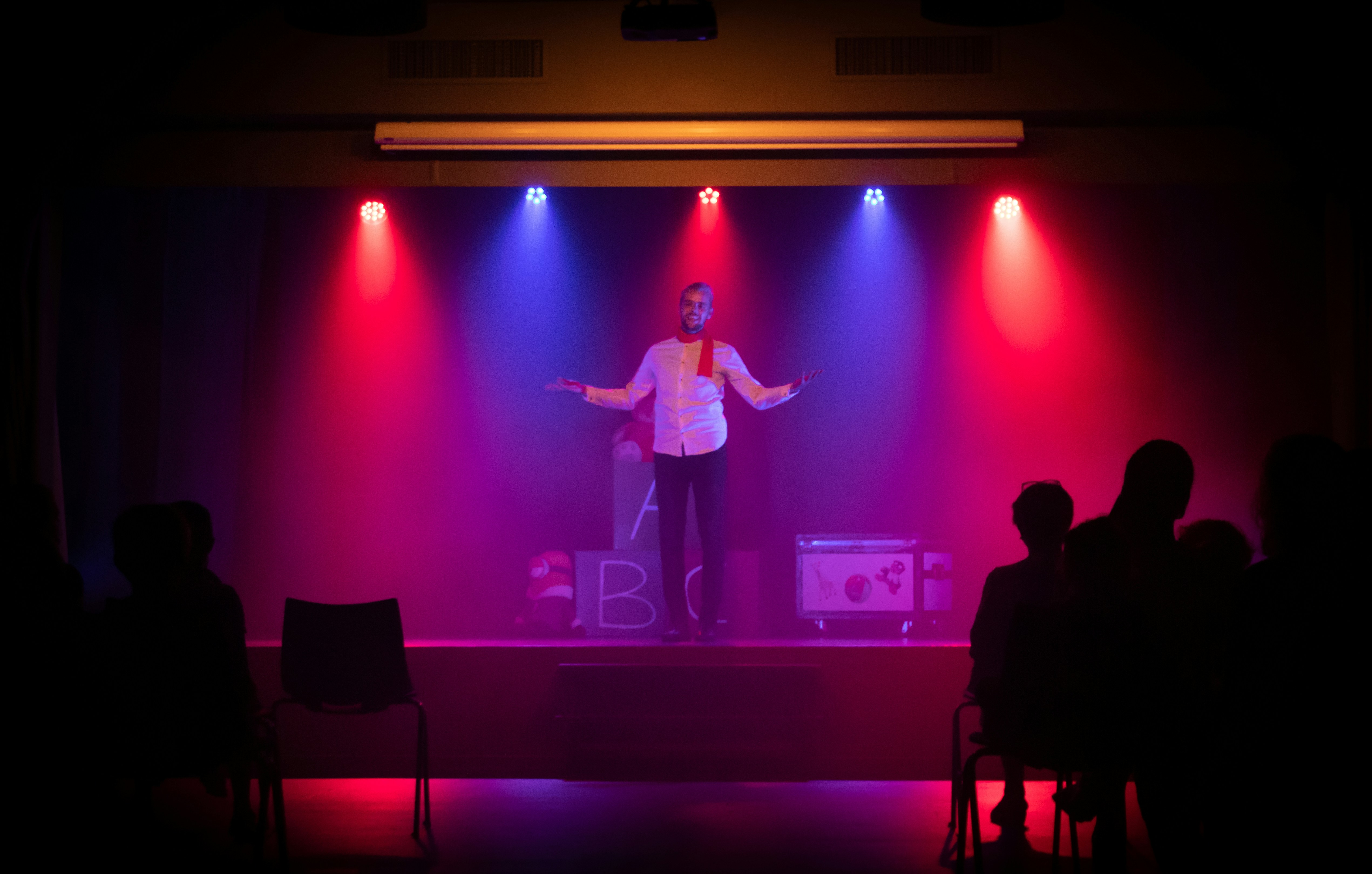 ⛩ Please support me by crediting my website michelgrolet.com or my Instagram @garnet_photographer ! by Magic Trick man in black shirt singing on stage