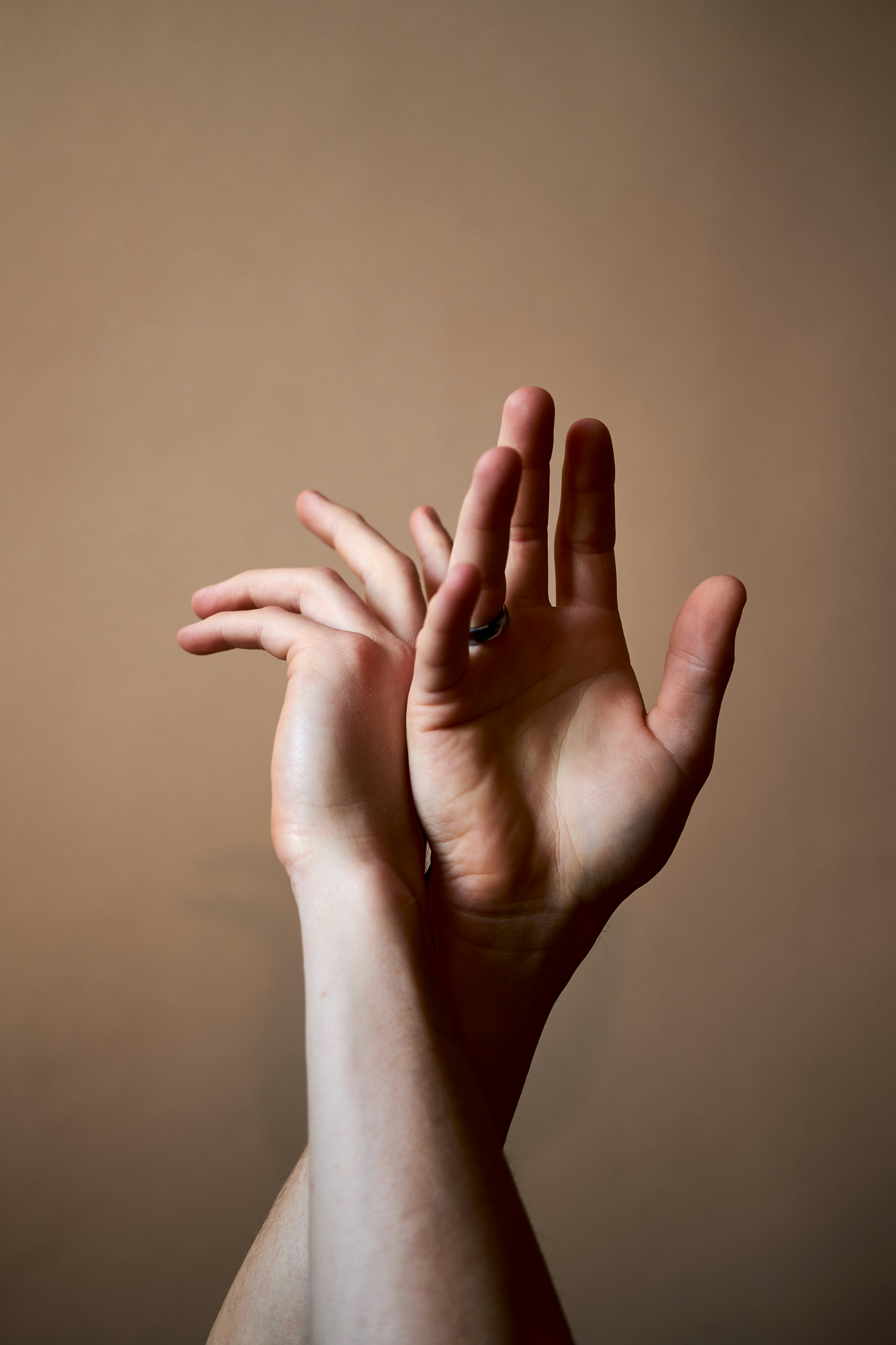 FAQ by Magic Trick persons left hand on white wall