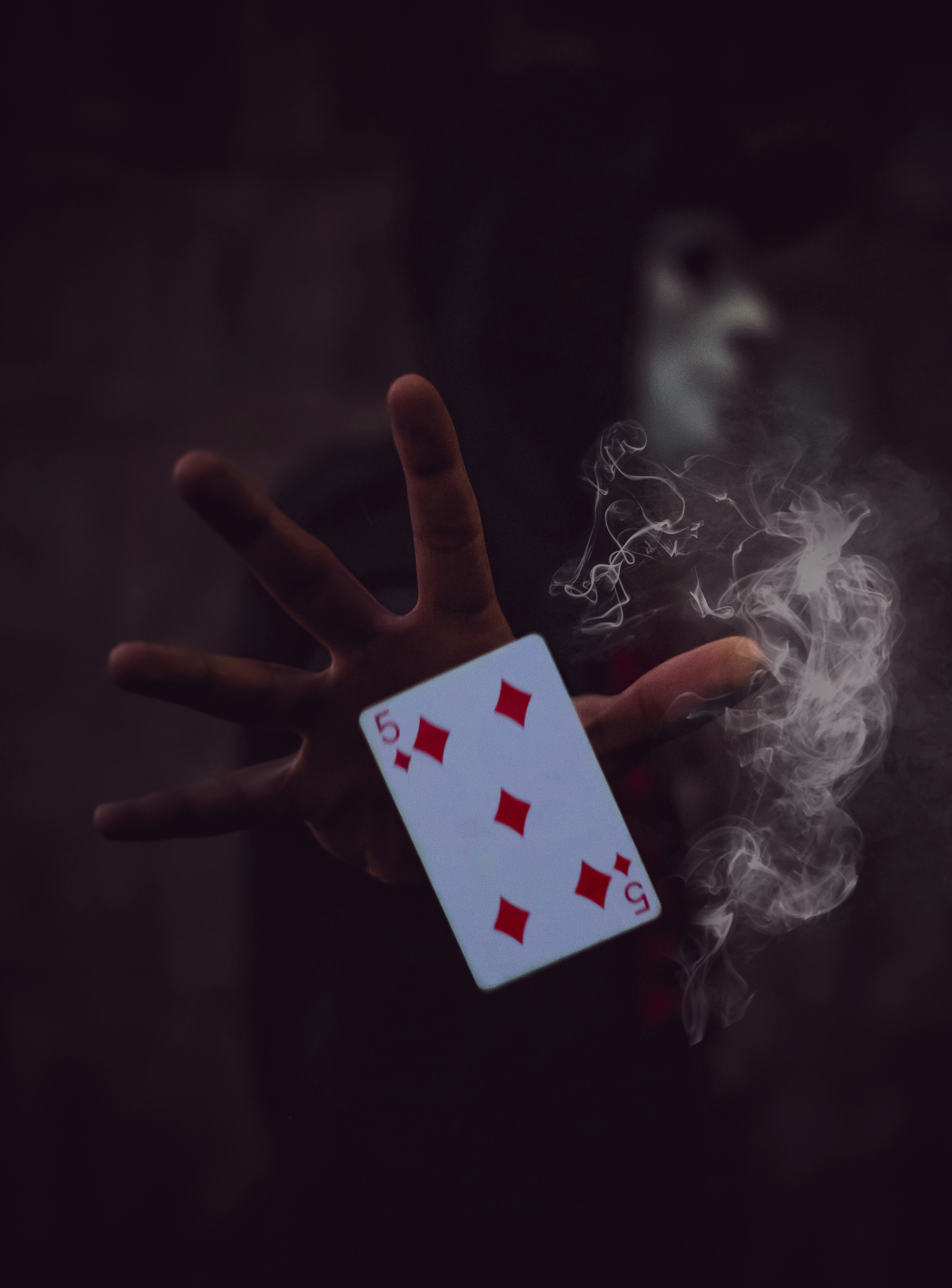 📜 From Ancient Sorcery to Modern Sleight: A Brief History of Magic's Evolution by Magic Trick person holding 5 of Diamonds playing card