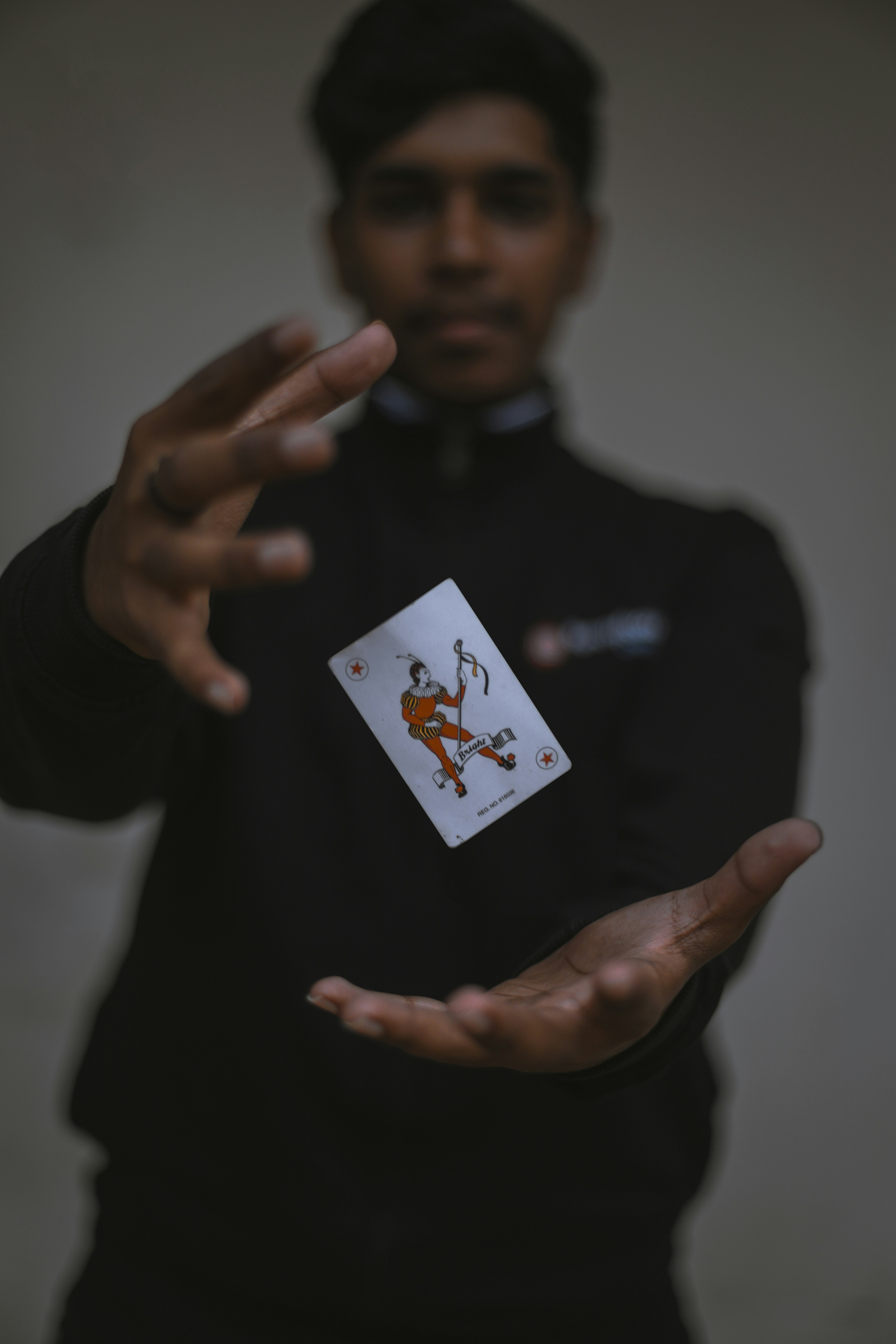 Madness by Magic Trick man holding playing card