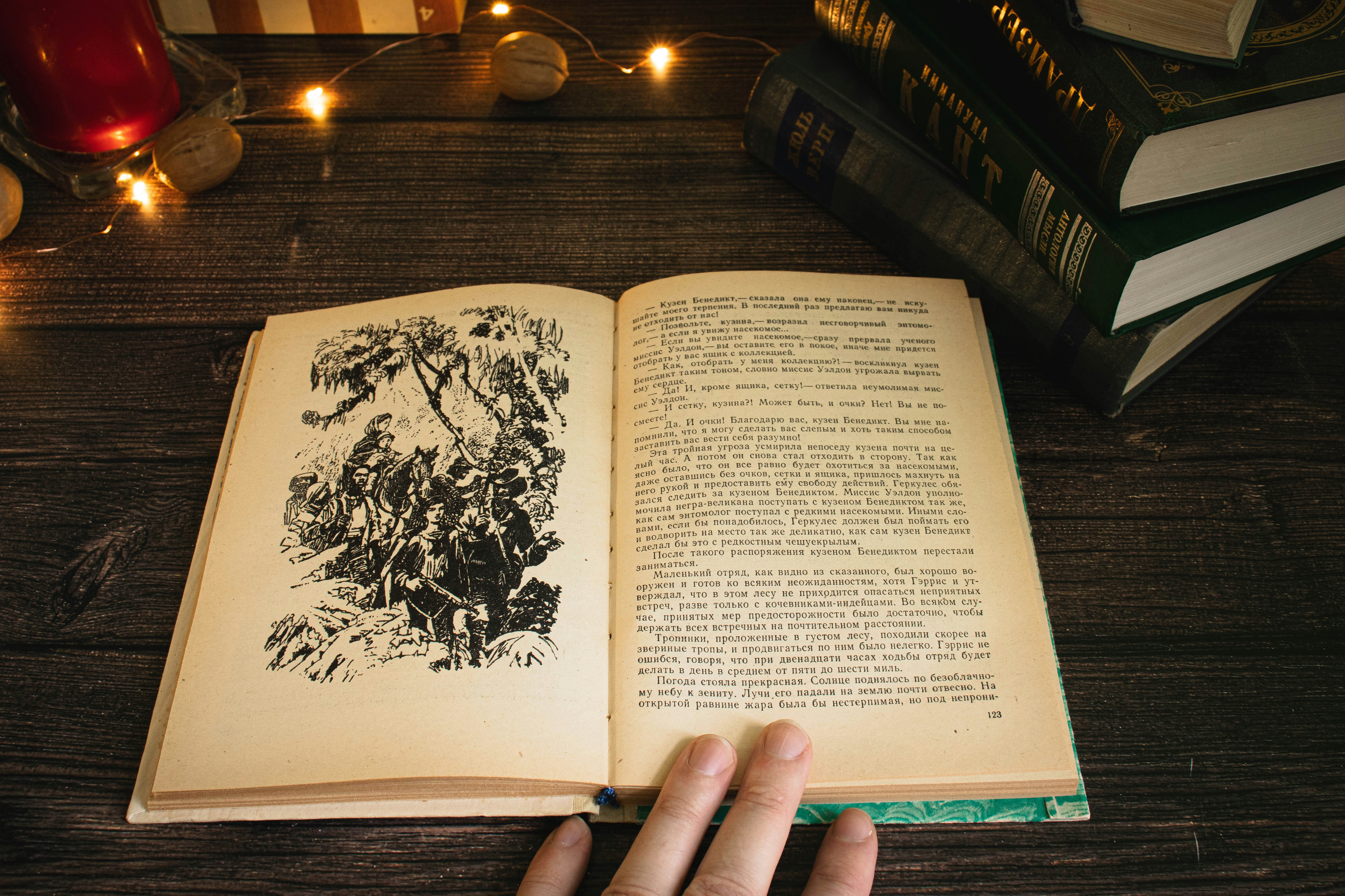 Book
by Magic Trick a hand holding an open book on top of a table
