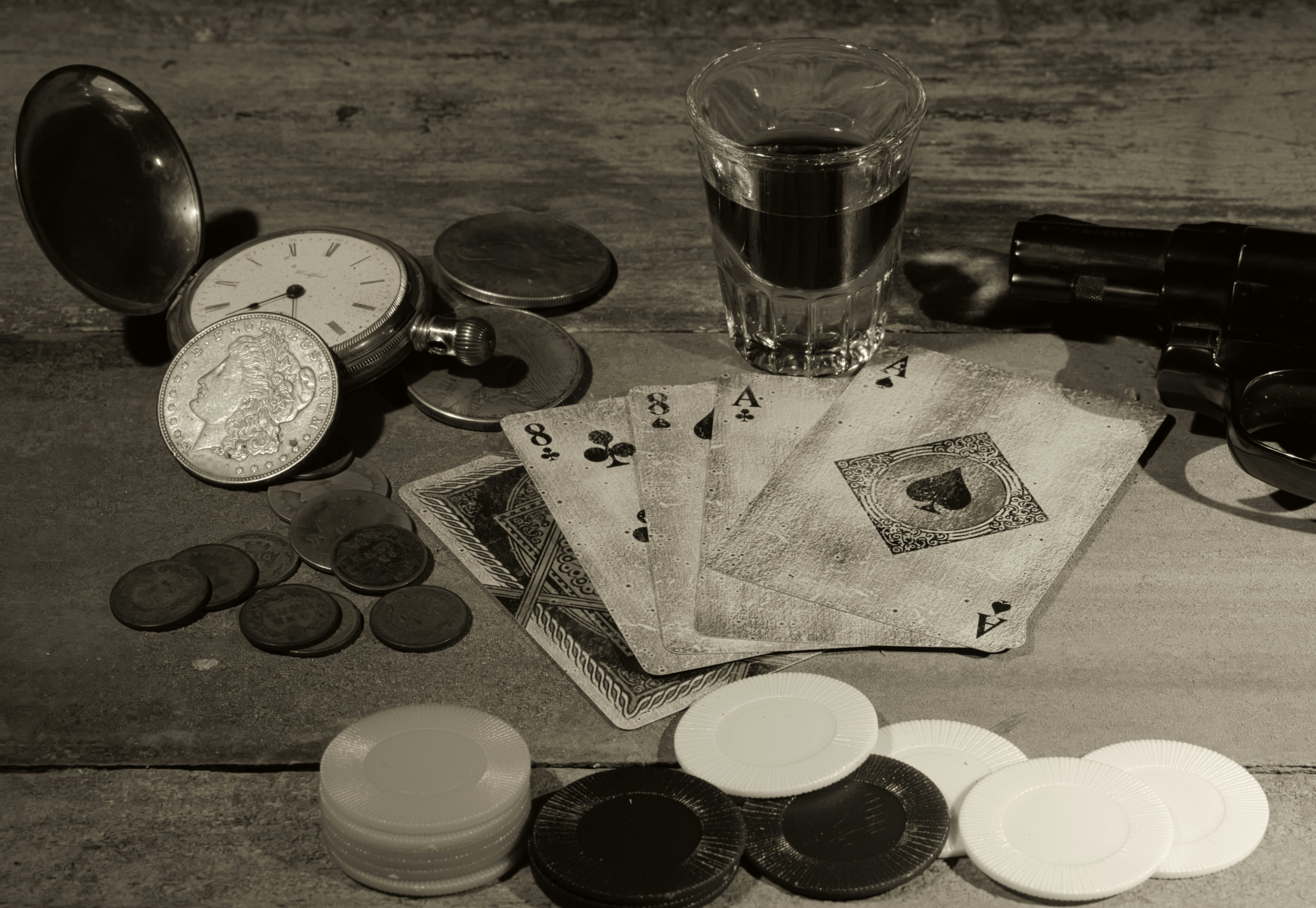 Wild Bill's dead man's hand by Magic Trick a table topped with lots of different items