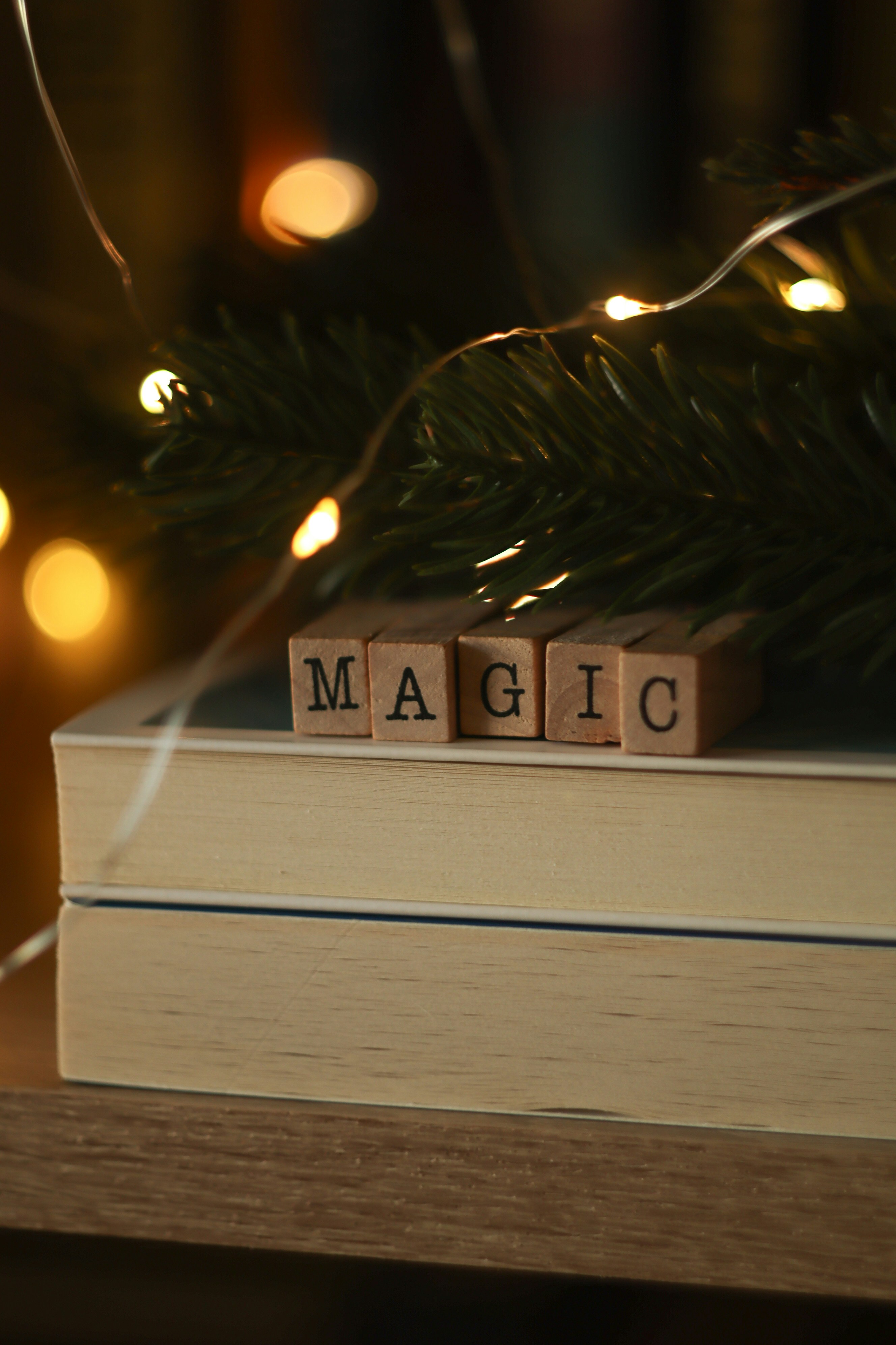 Magic moments ✨ by Magic Trick A wooden block spelling the word magic on top of a book