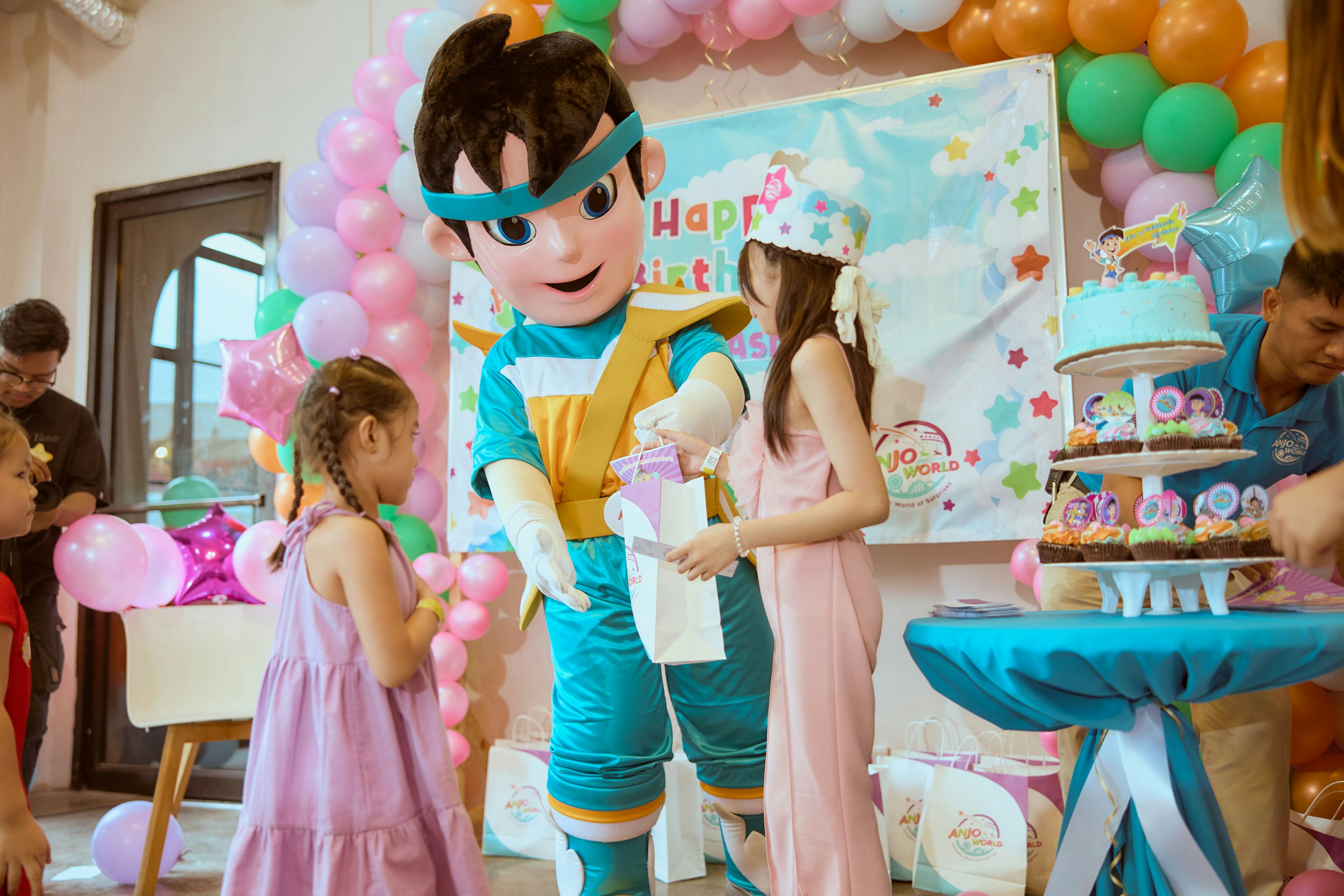 Kids party by Magic Trick Mascot giving gift to girl at birthday party