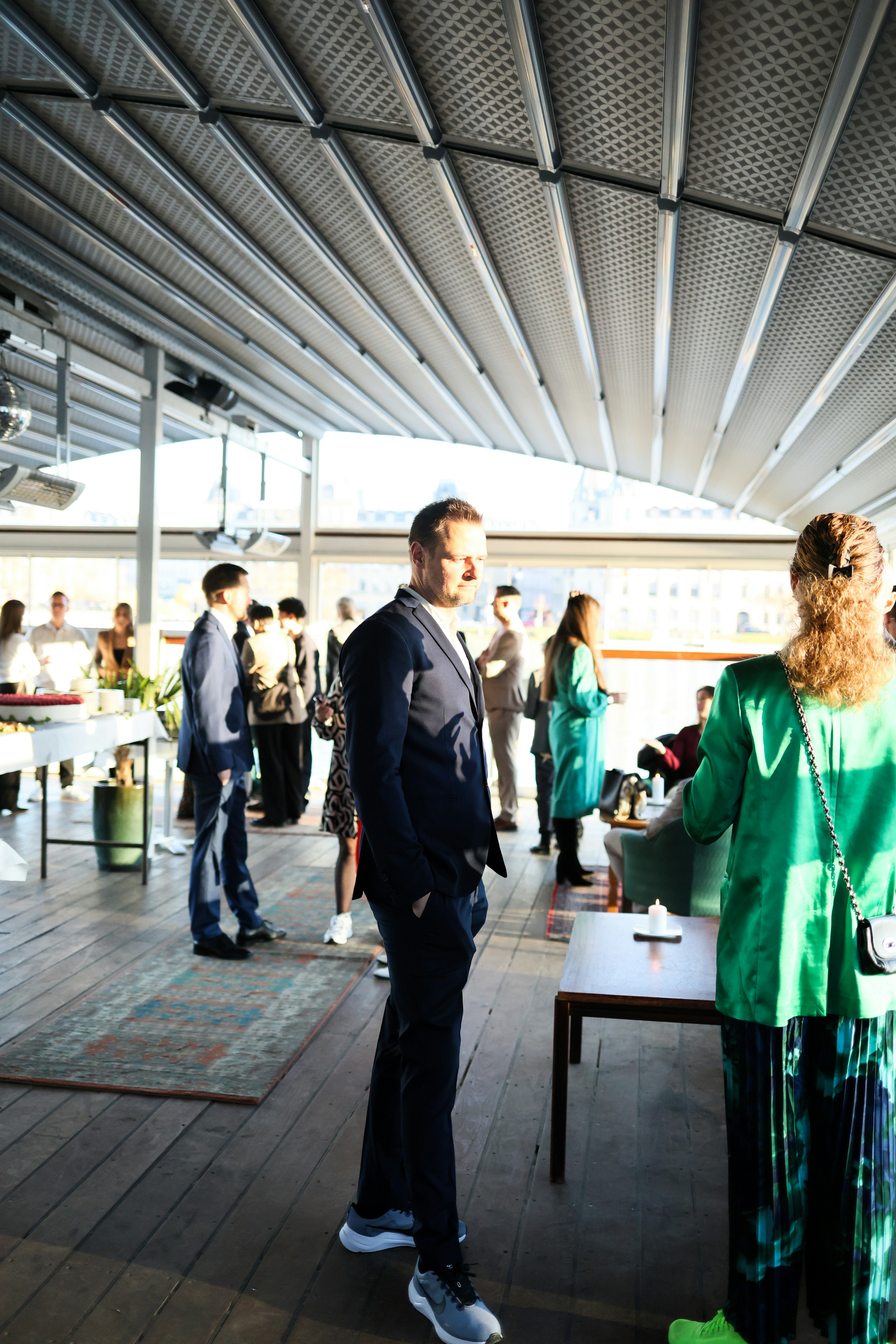 🏆 Conclusion by Magic Trick People mingling at an outdoor event with a retractable roof.