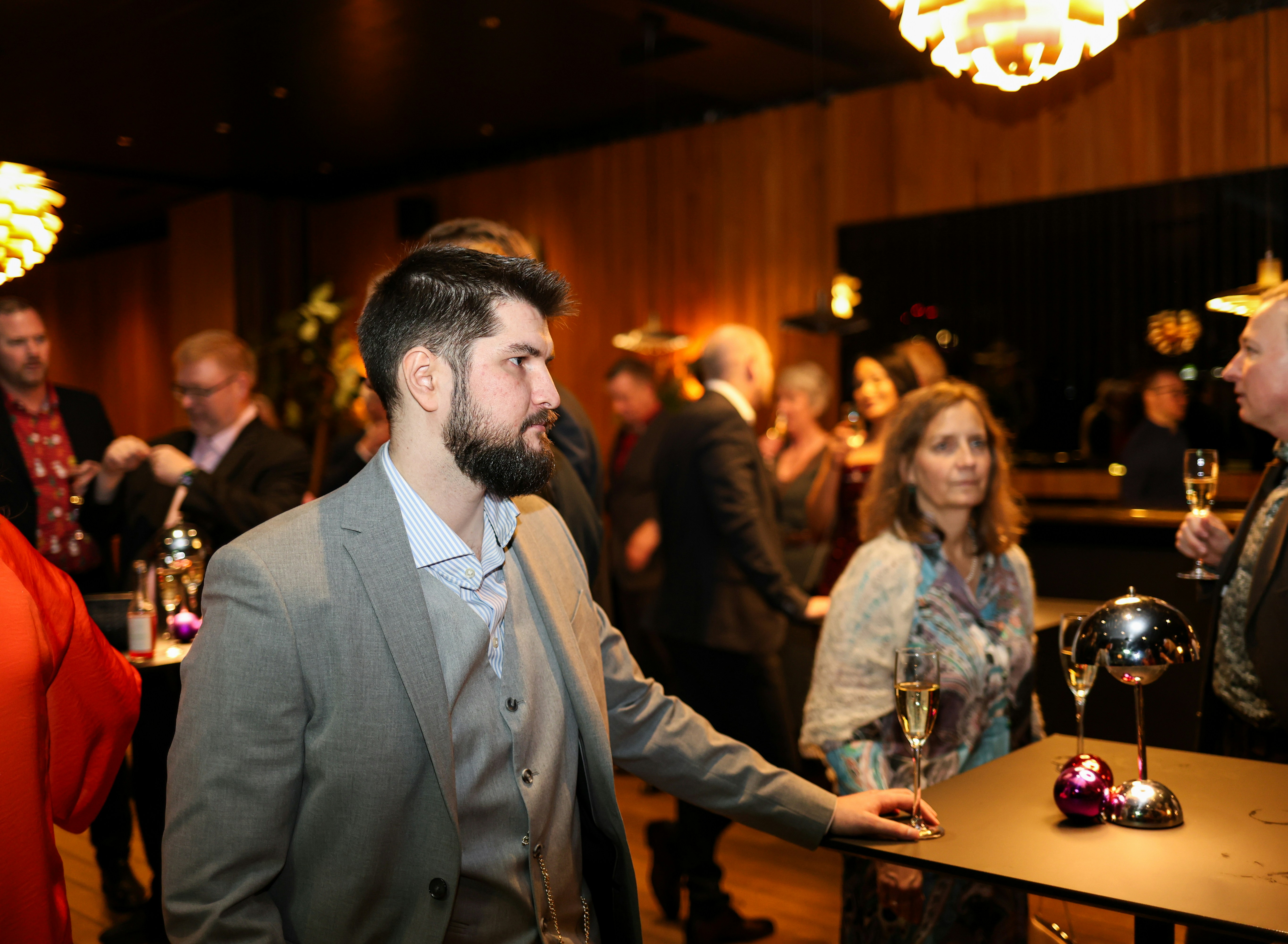 ❓ FAQ by Magic Trick People mingling at a formal event with drinks.