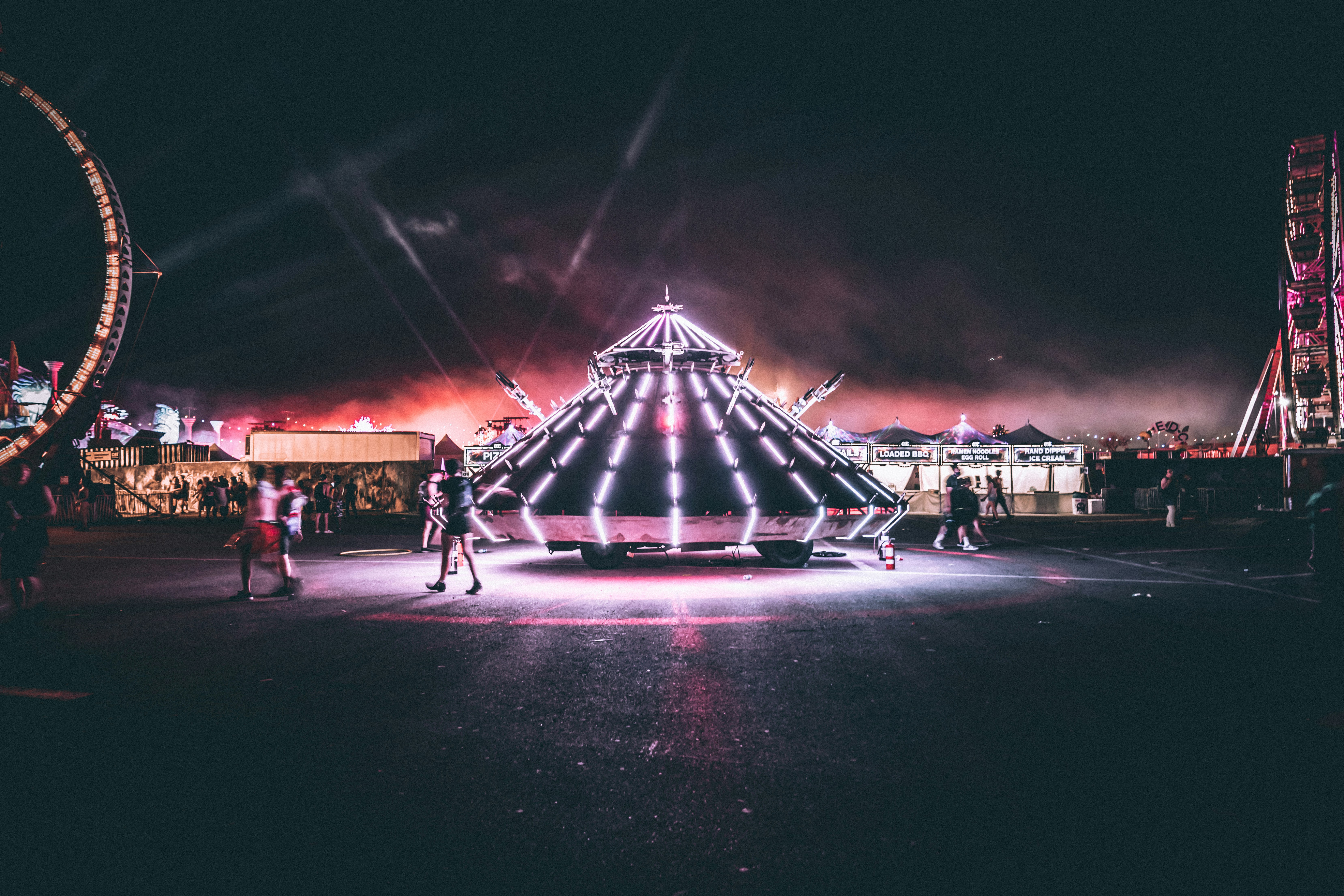 The Human Aliens. by Magic Trick person standing near triangular carnival ride