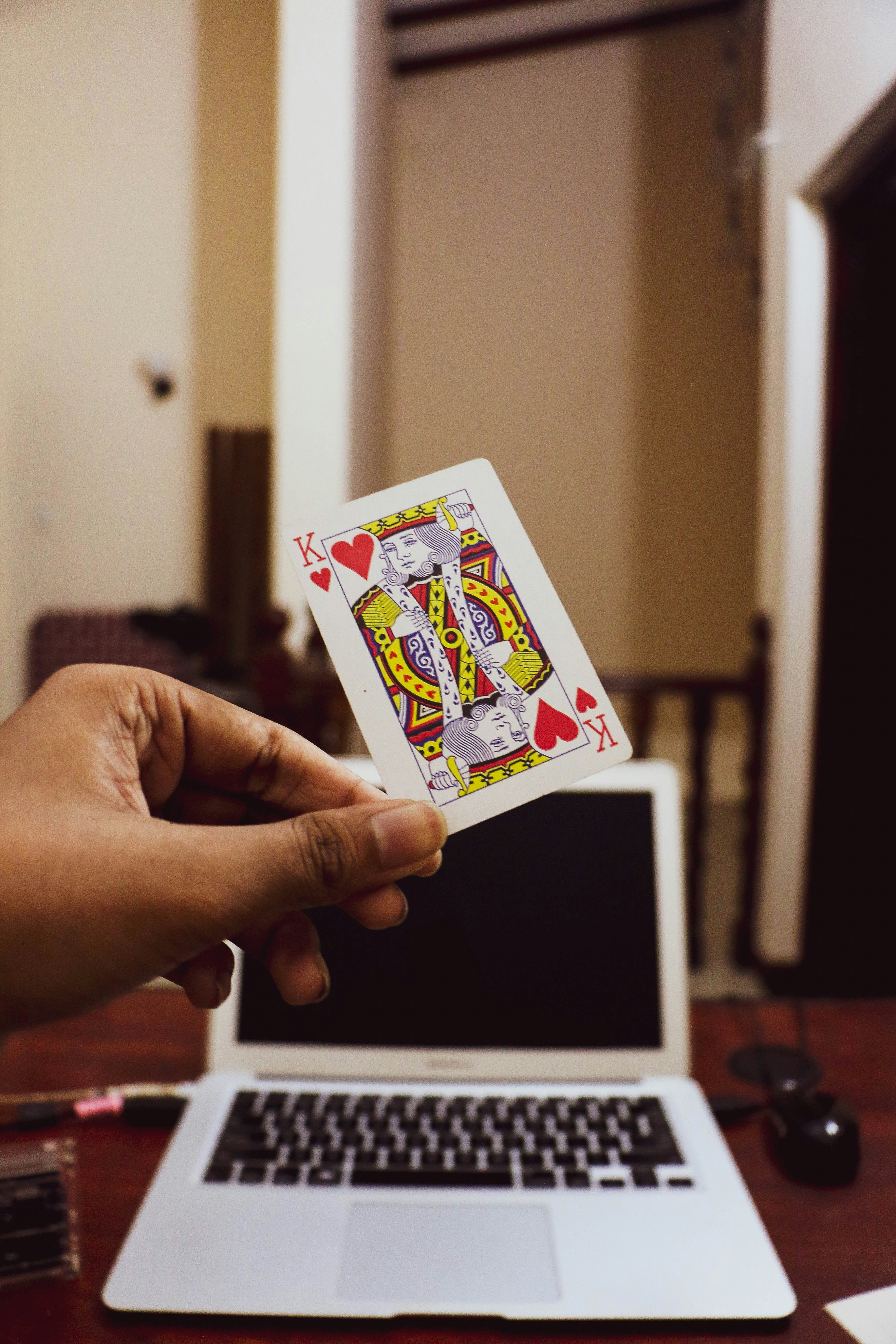 🏁 Conclusion by Magic Trick a person holding a playing card in front of a laptop
