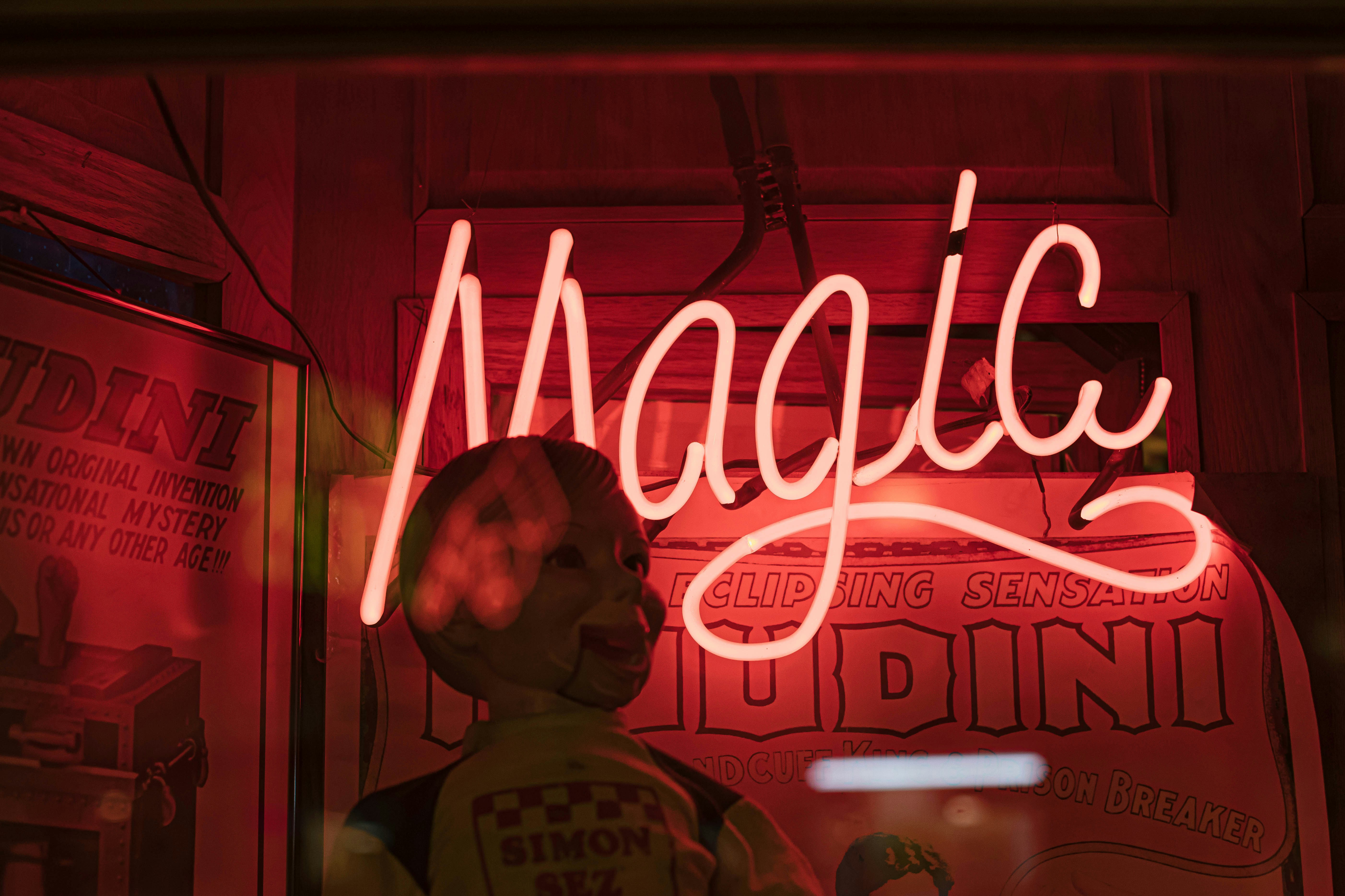❓ FAQ by Magic Trick a neon sign that reads magic behind a mannequin