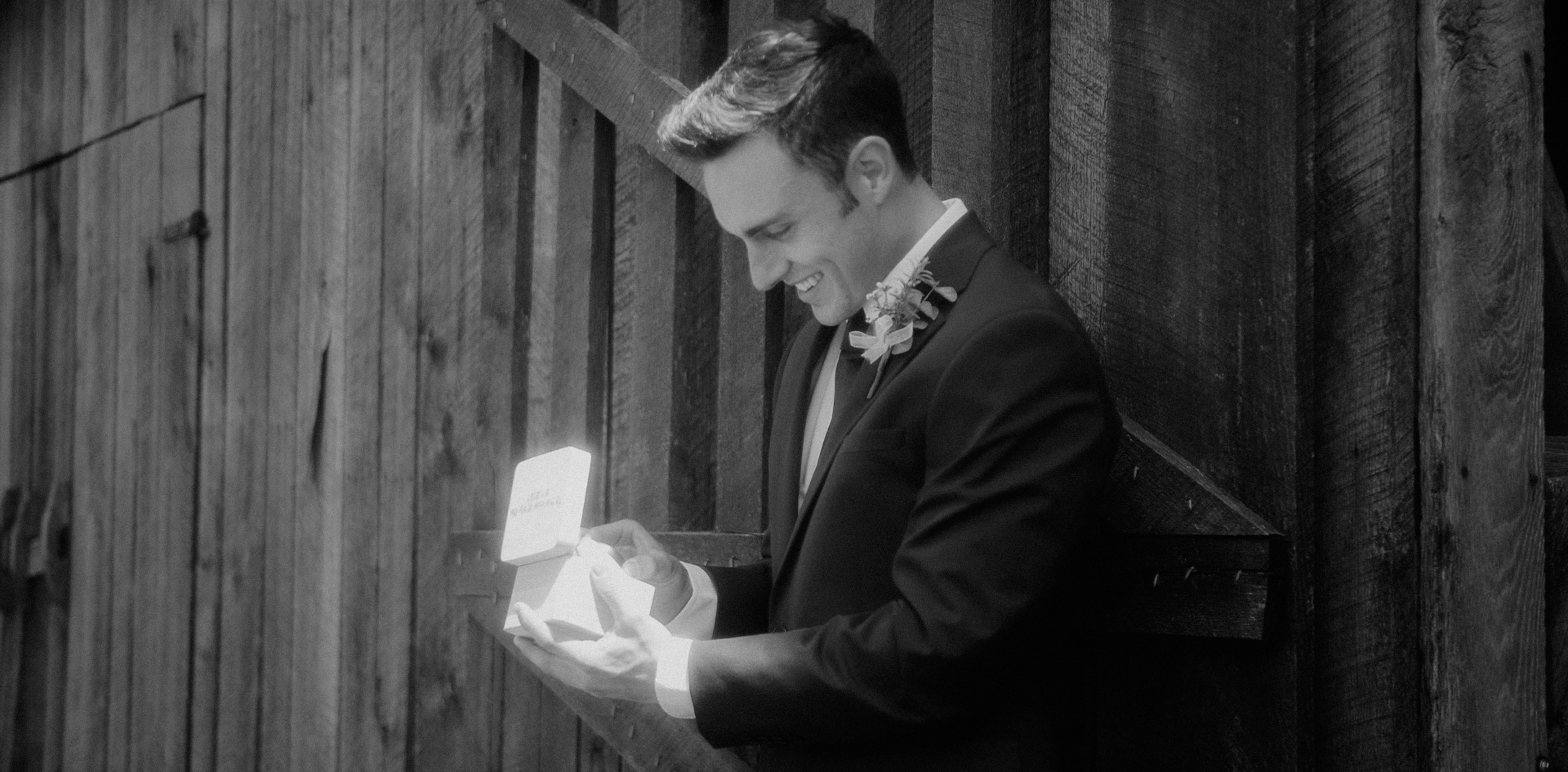 This is a still frame from a 550Park Wedding Film. 550Park is A Luxury Wedding Film Studio based out of New York City. Traveling Worldwide for our Couples. Films by Brent Szklaruk. Wedding packages begin at $1,500. by Magic Trick a man in a suit is holding a box