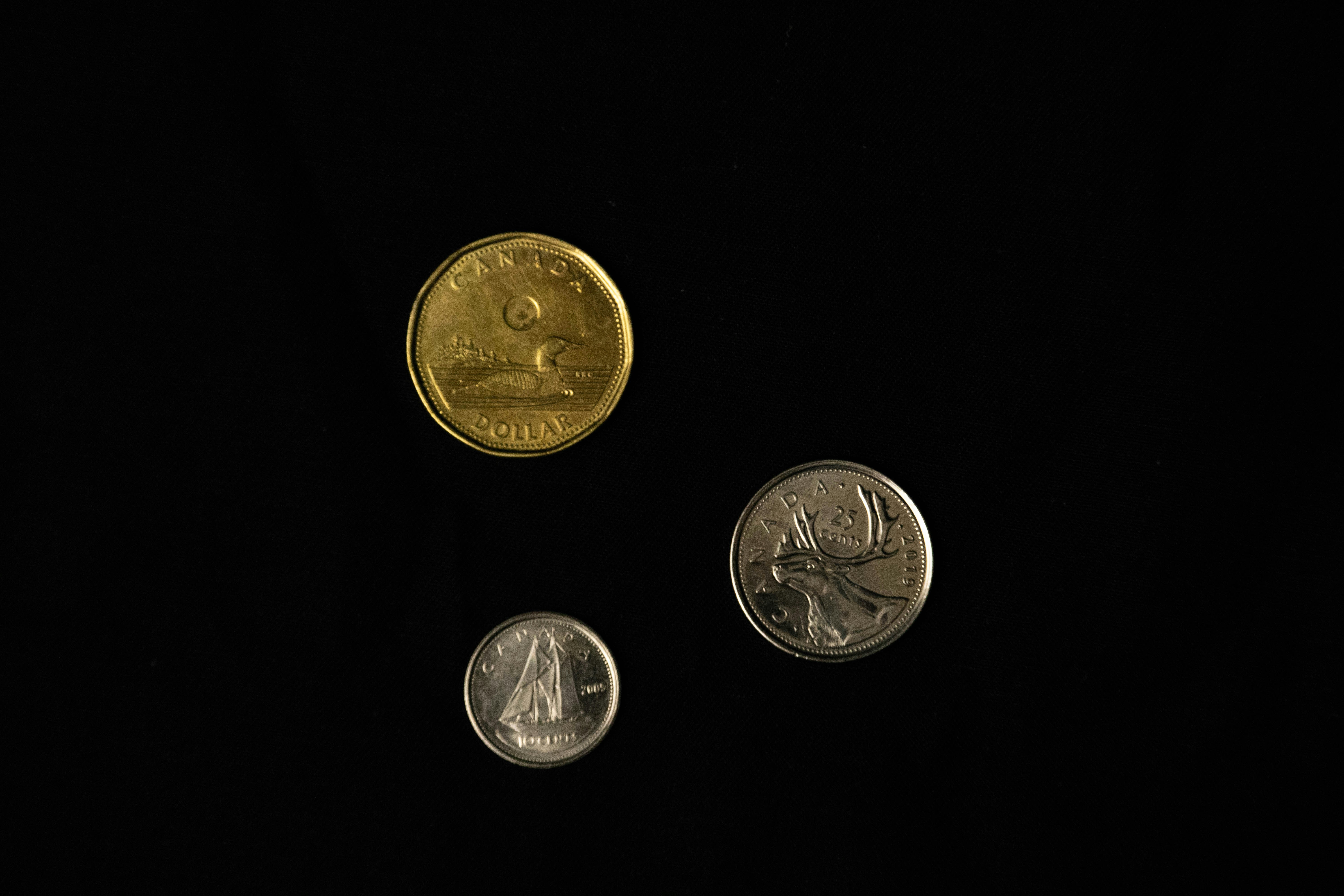 2 silver round coins on black surface