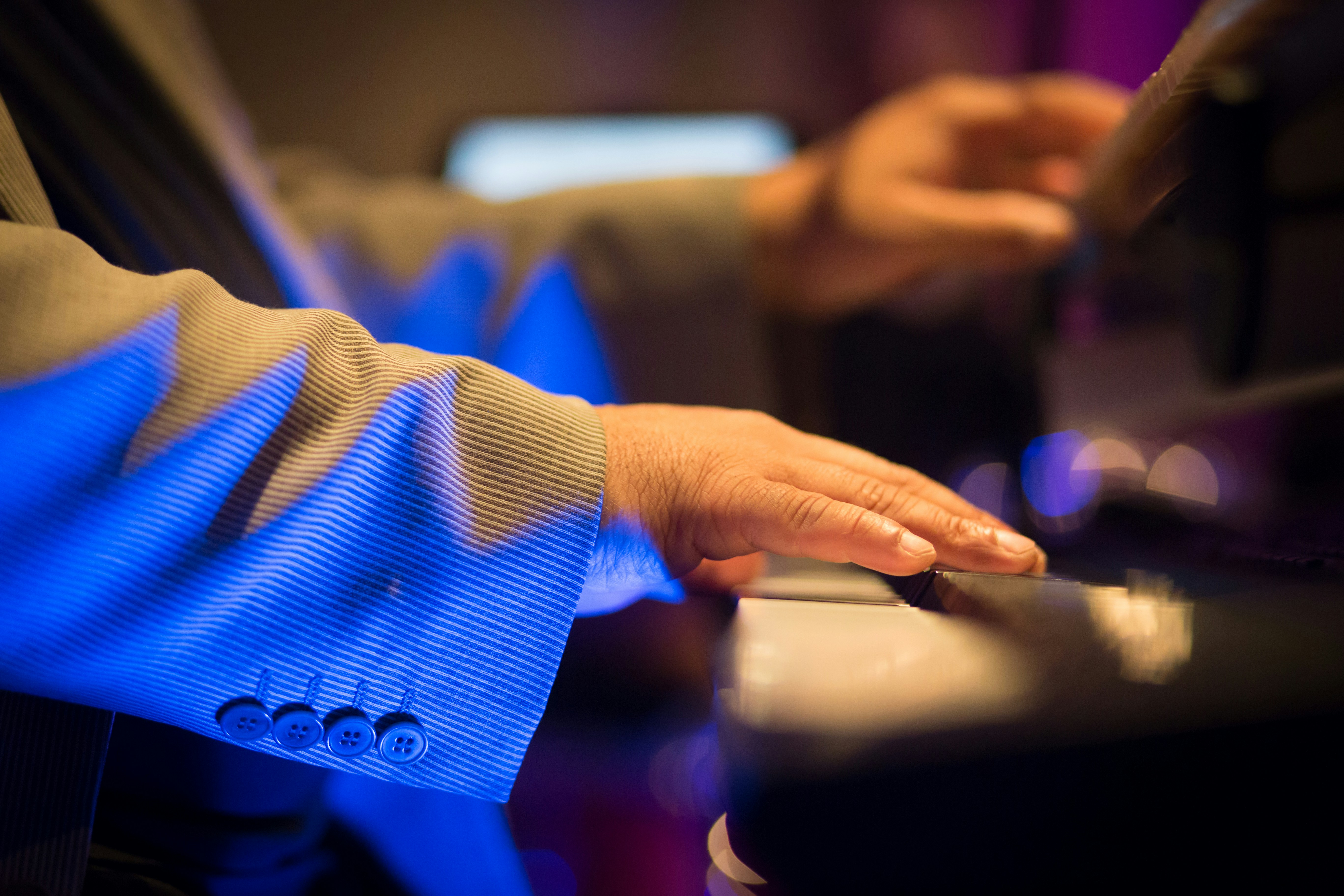 Pianists Hands by Magic Trick person in blue long sleeve shirt