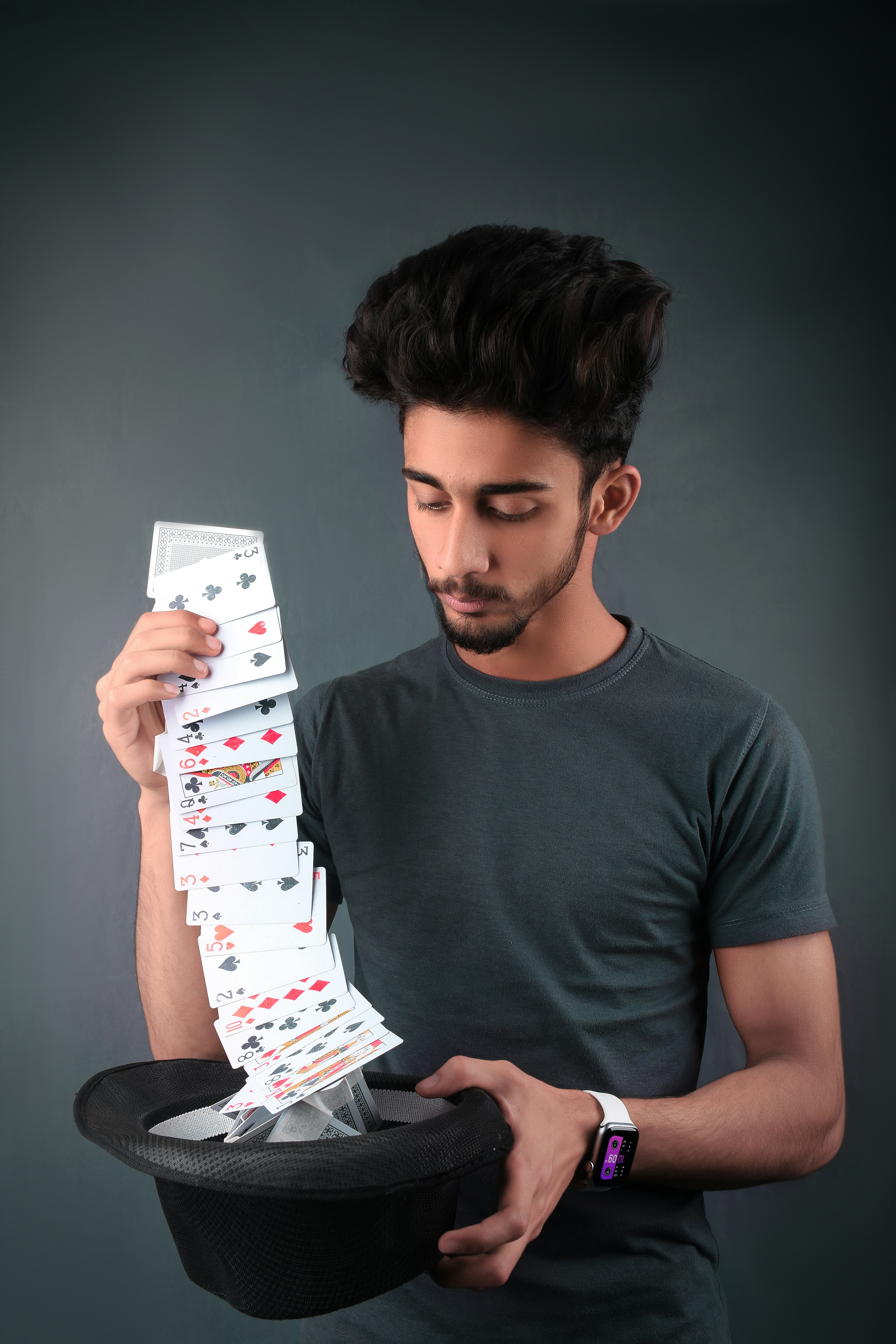 I really believe there are things nobody would see if I didn't photograph them. by Magic Trick man in gray crew neck t-shirt holding white and red playing cards
