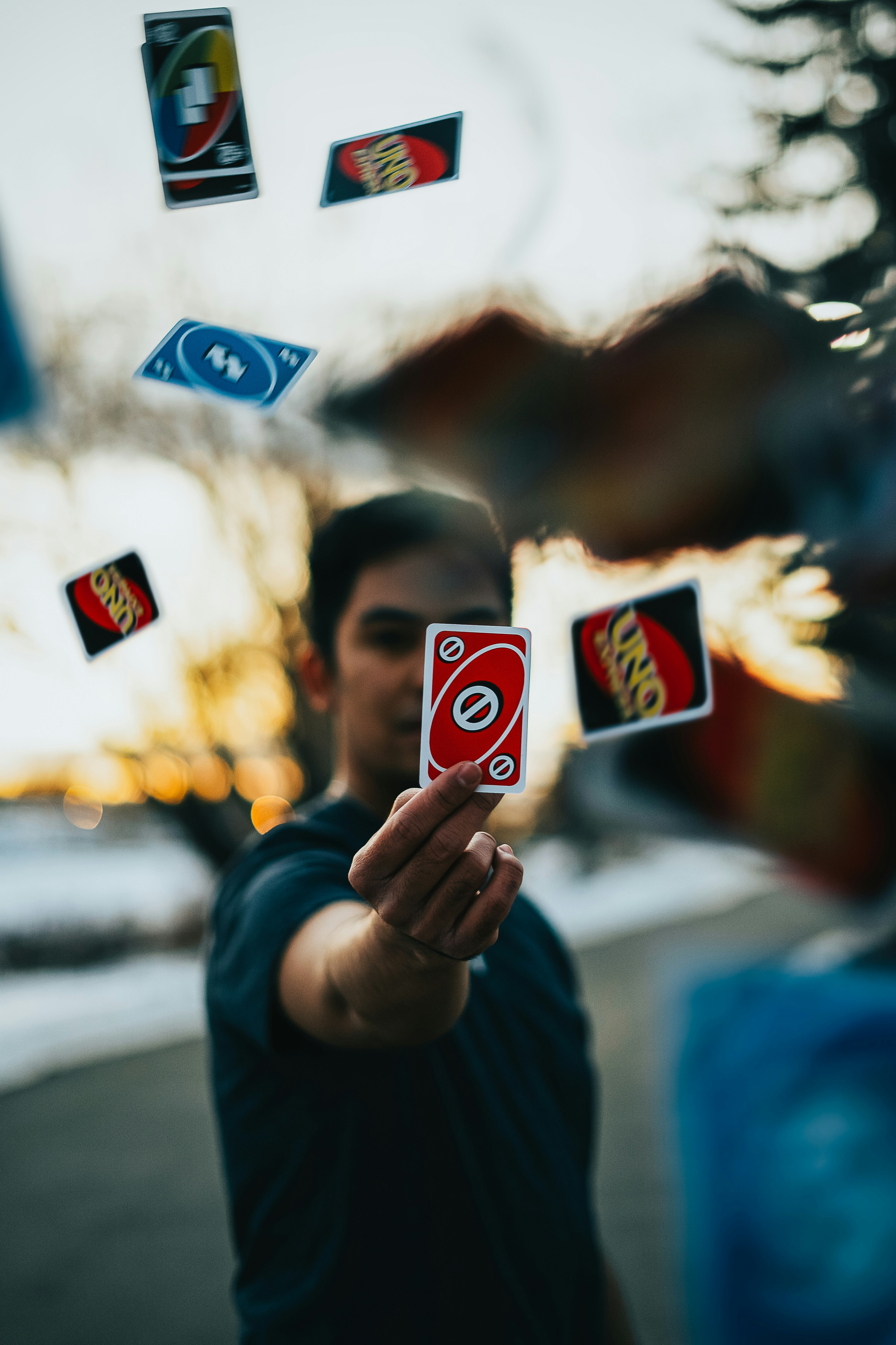 Time skip using uno cards by Magic Trick a man holding up a red and white playing card