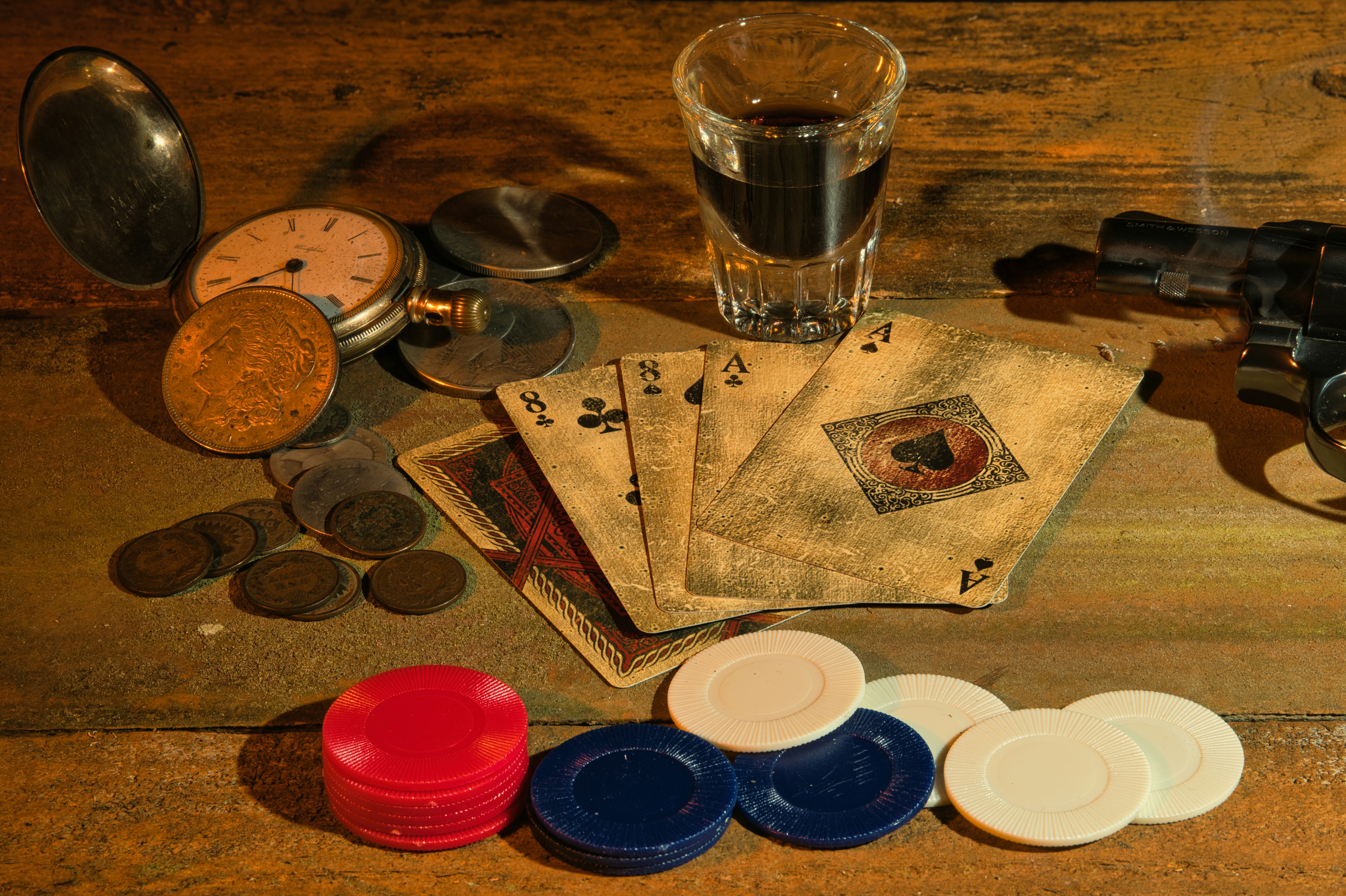 Dead Man's Hand by Magic Trick a wooden table topped with lots of different items