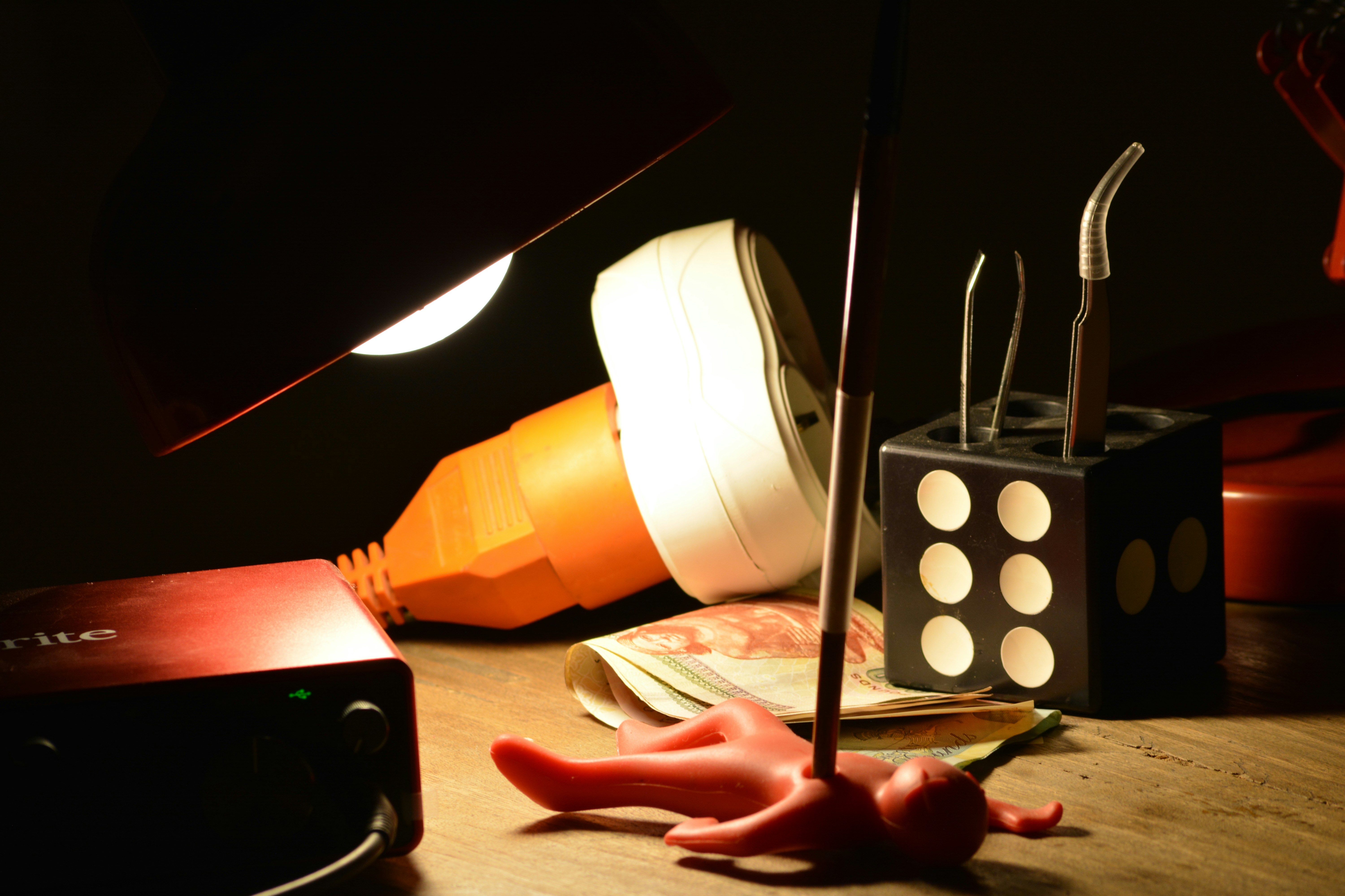 FAQ by Magic Trick A table topped with a lamp and a cell phone