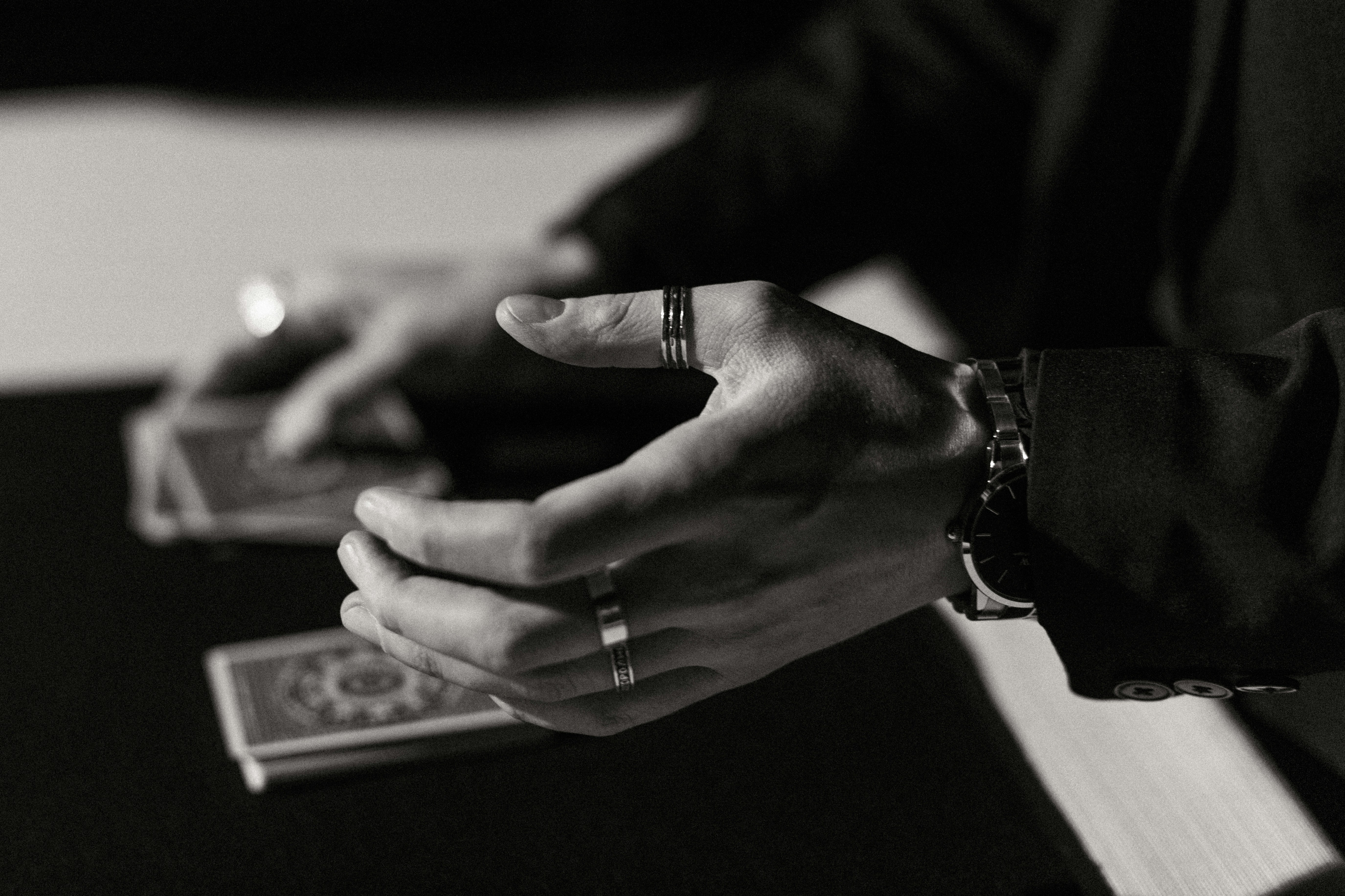 Magic moment. by Magic Trick A black and white photo of a person holding a cell phone