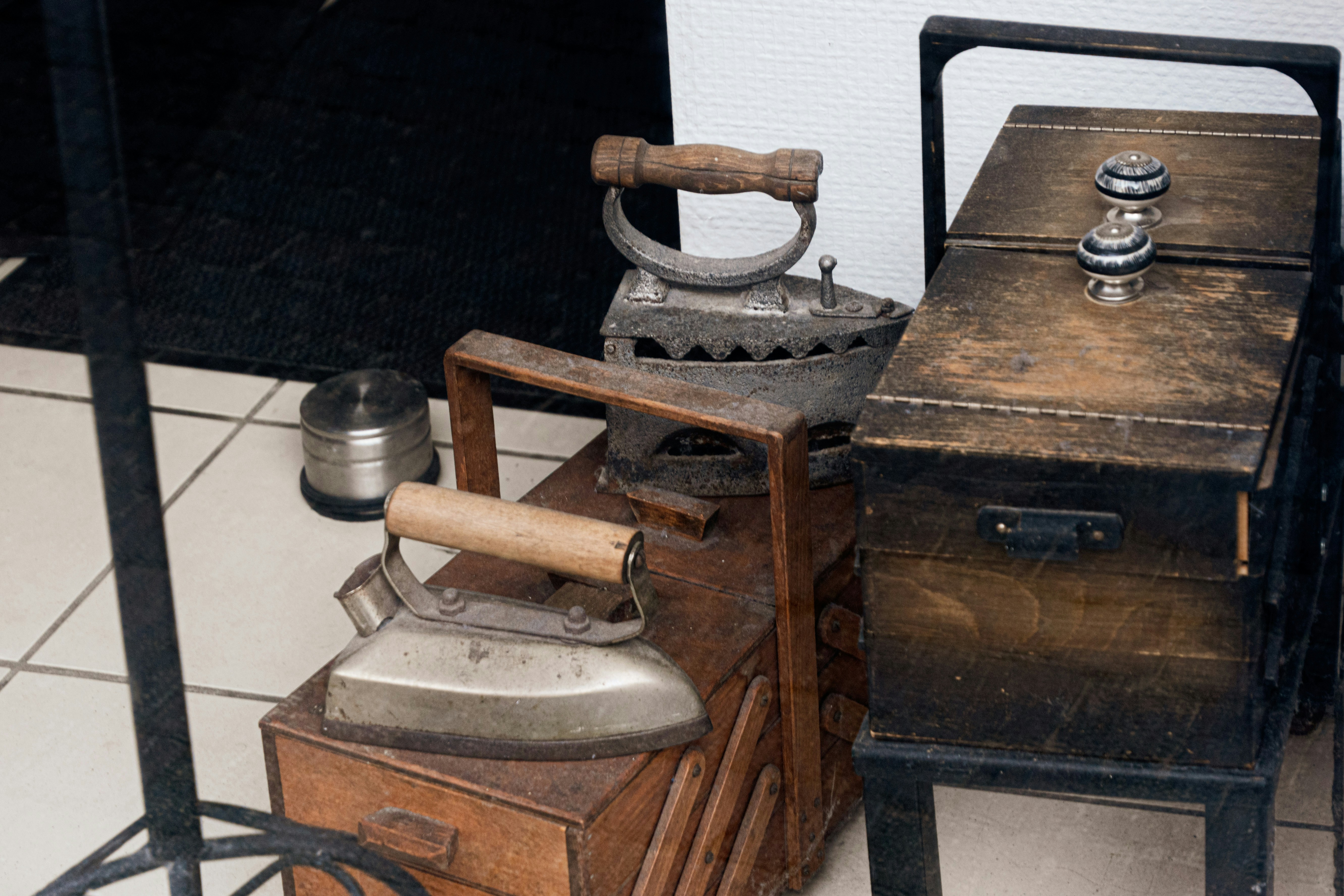📜 The Secret History of DIY Magic with Everyday Objects by Magic Trick Three antique irons resting on wooden boxes
