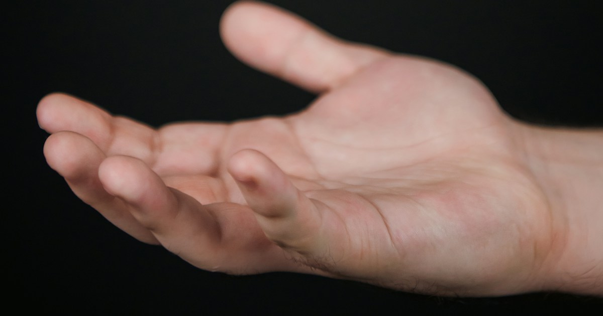 📚 The Psychology and History of Cognitive Biases in Magic by Magic Trick A hand holding a rubik cube in the air