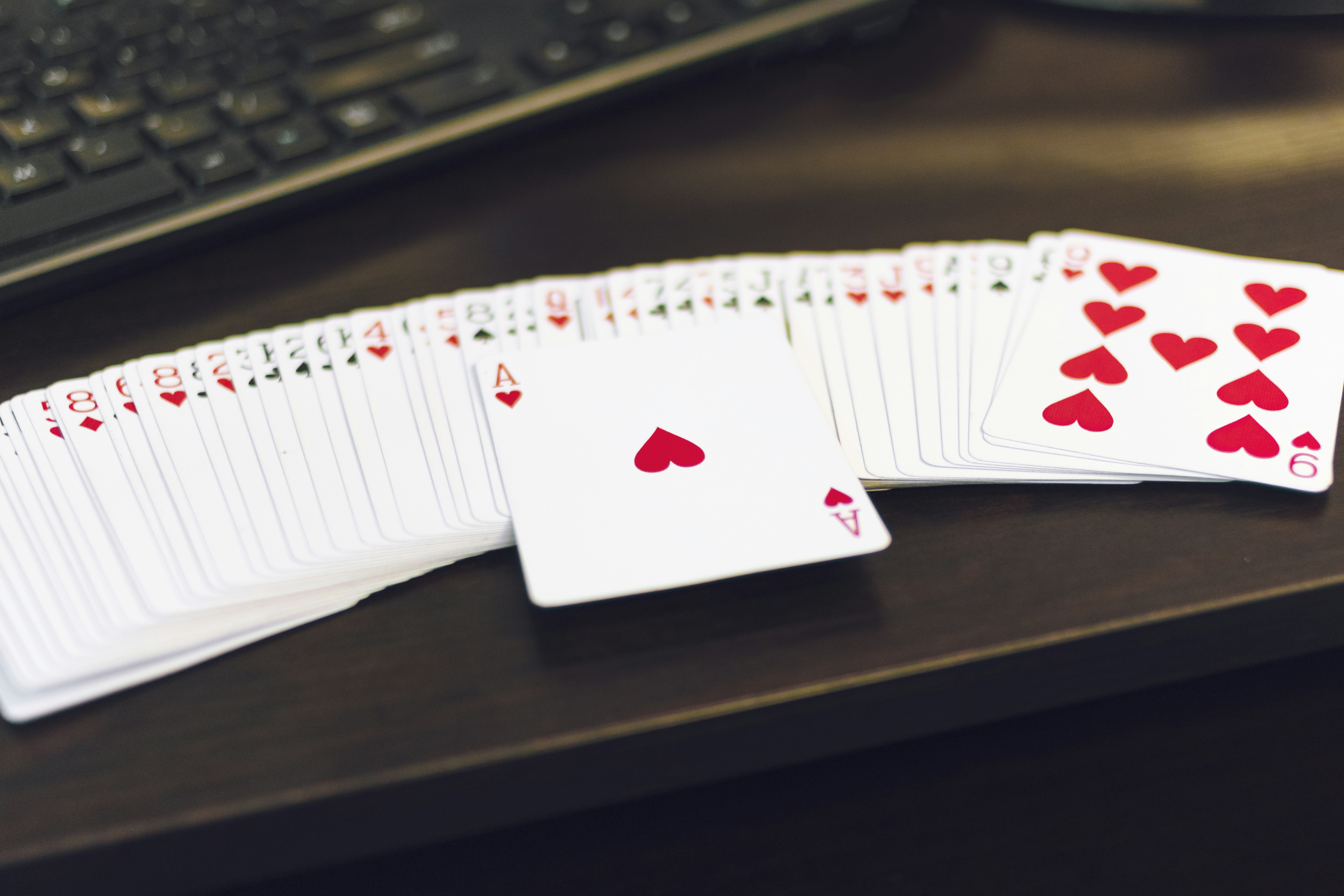 Play the right cards by Magic Trick white and red playing cards on white paper