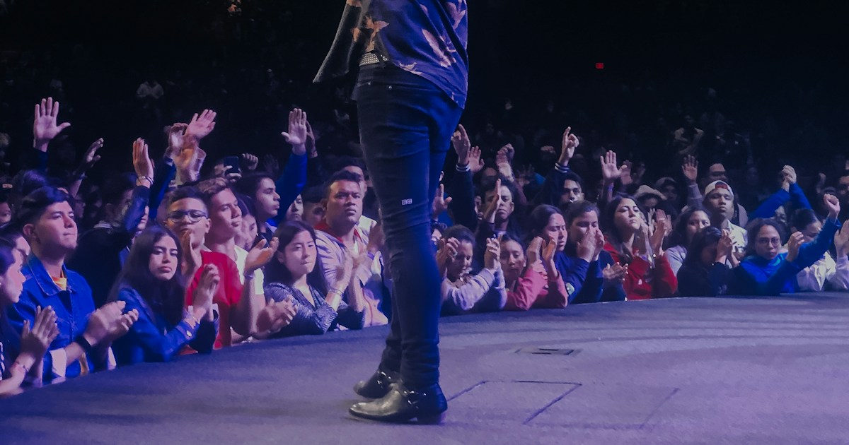 📜 A Brief History of Magic, Wonder, and Emotion by Magic Trick man in blue shirt standing on stage