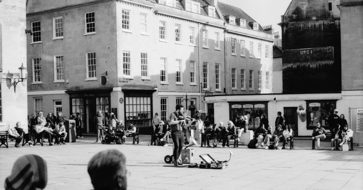 Shot on a Canon AE-1 with Fomapan 200 by Magic Trick a black and white photo of people sitting on benches